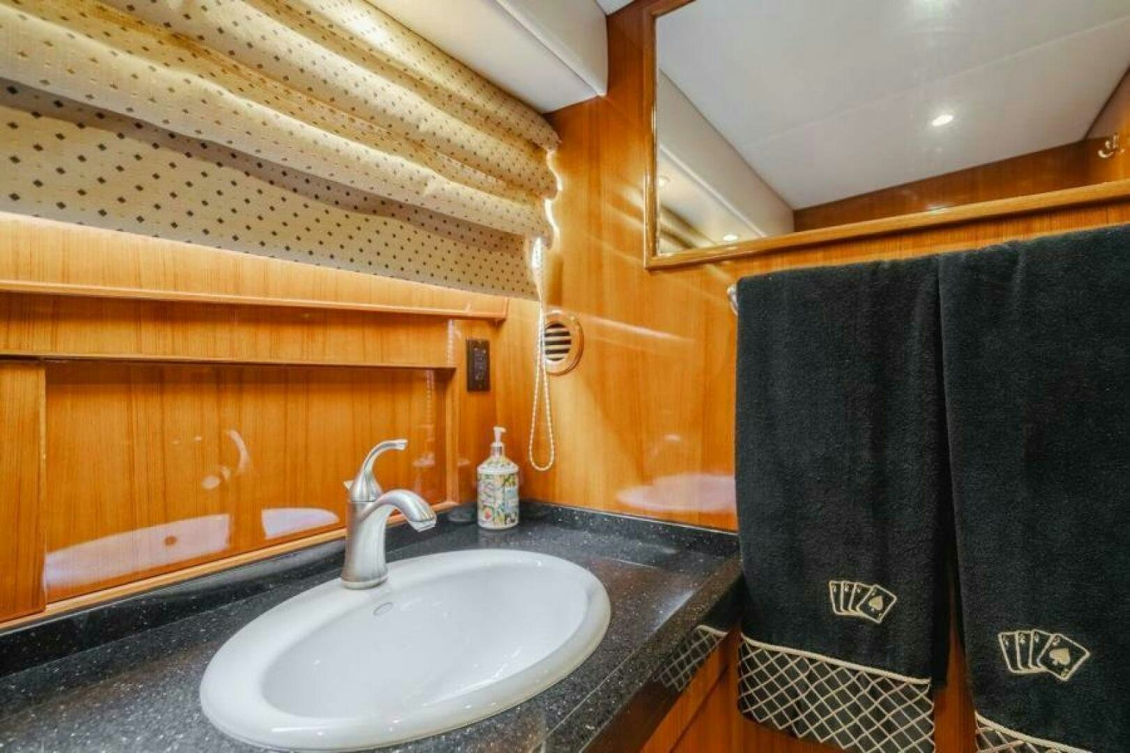 a bathroom with a sink and a towel on the wall aboard FAN TAIL I Yacht for Sale