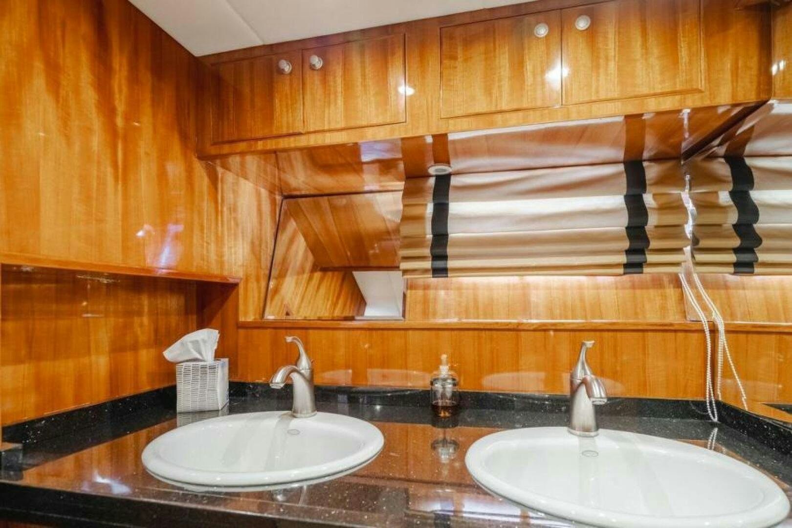 a bathroom with wooden cabinets aboard FAN TAIL I Yacht for Sale