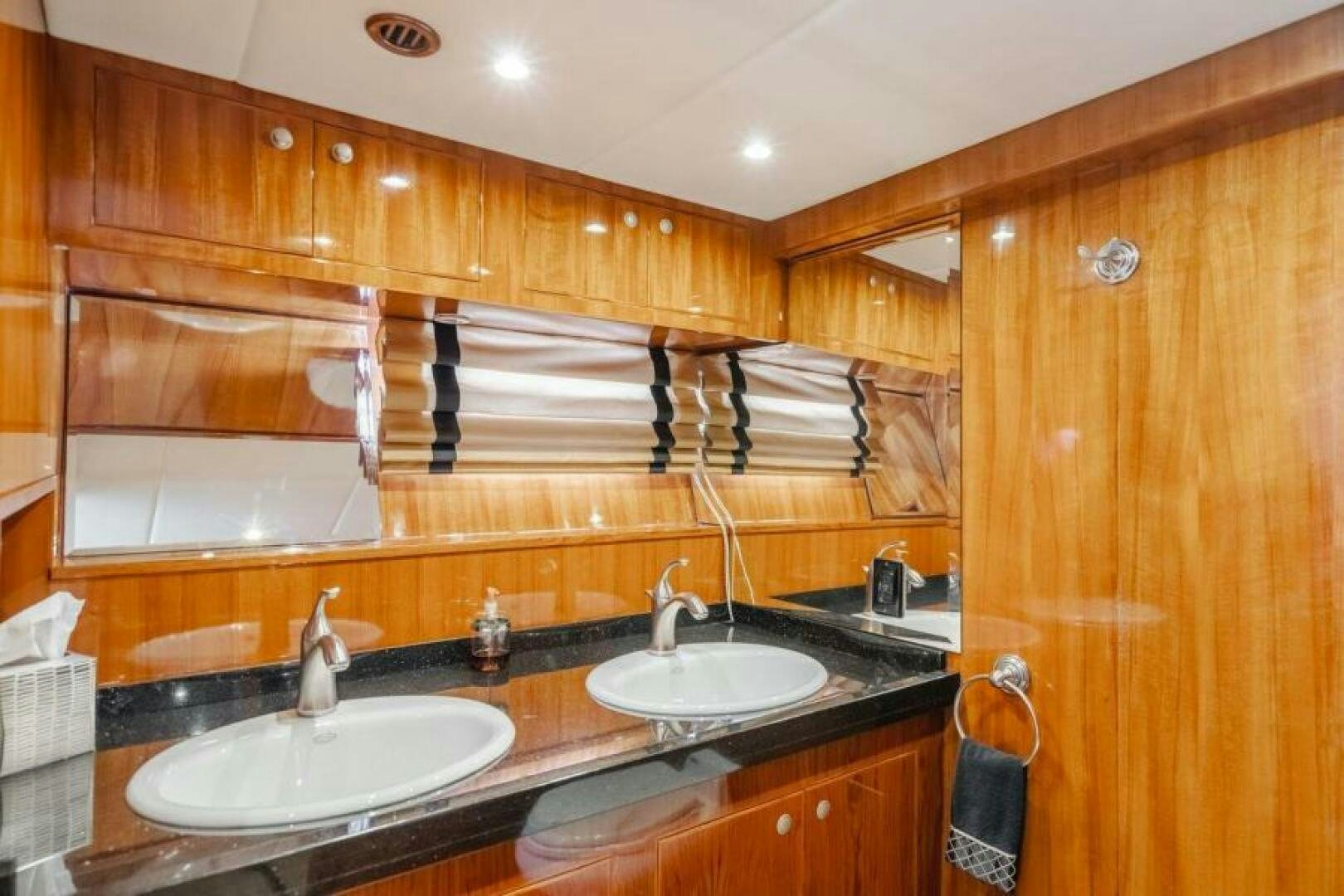 a bathroom with wooden cabinets aboard FAN TAIL I Yacht for Sale