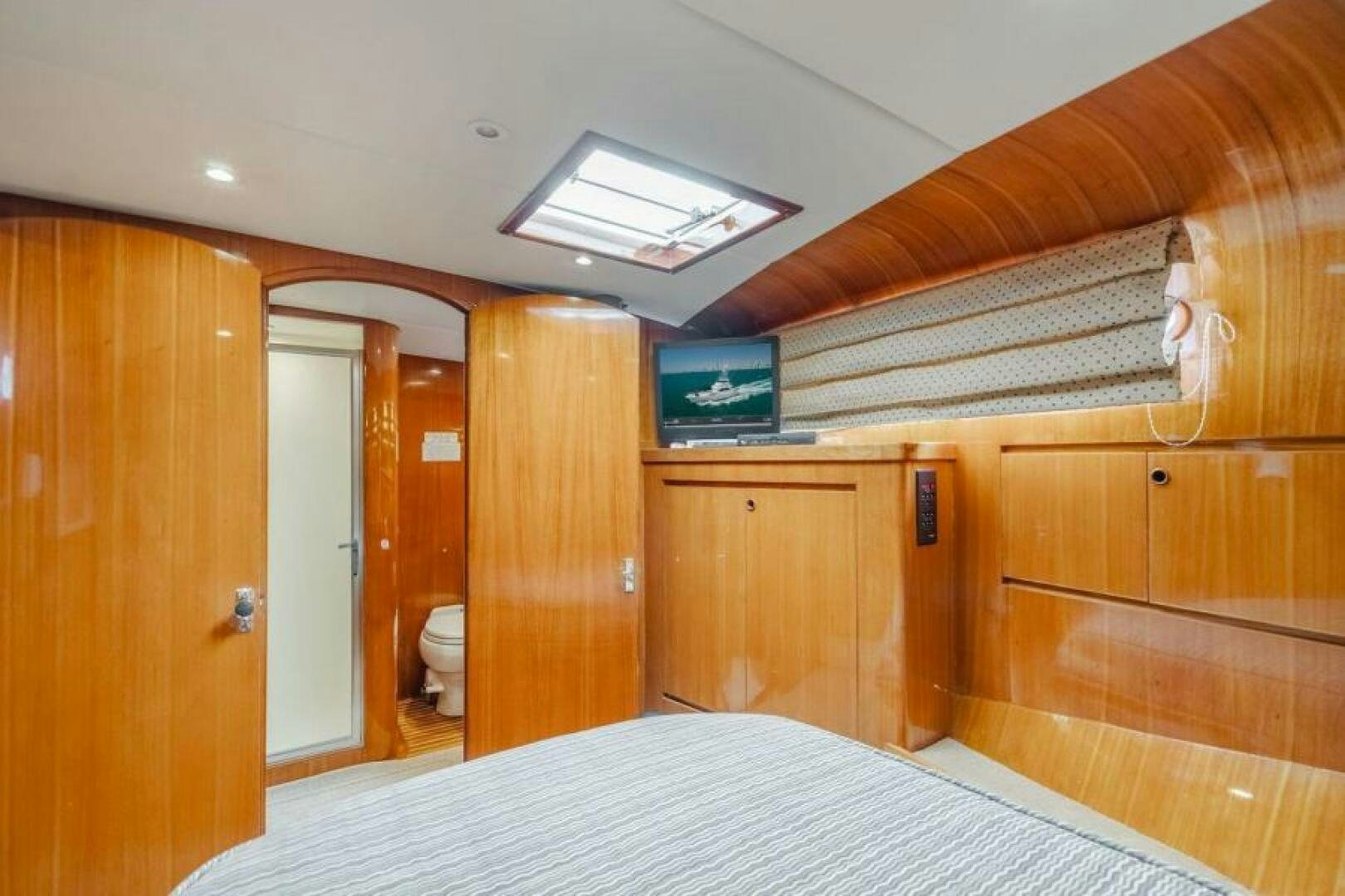 a room with a bed and a tv on the wall aboard FAN TAIL I Yacht for Sale
