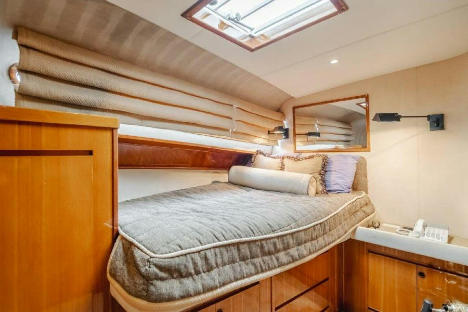 a bed with a wooden headboard aboard FAN TAIL I Yacht for Sale