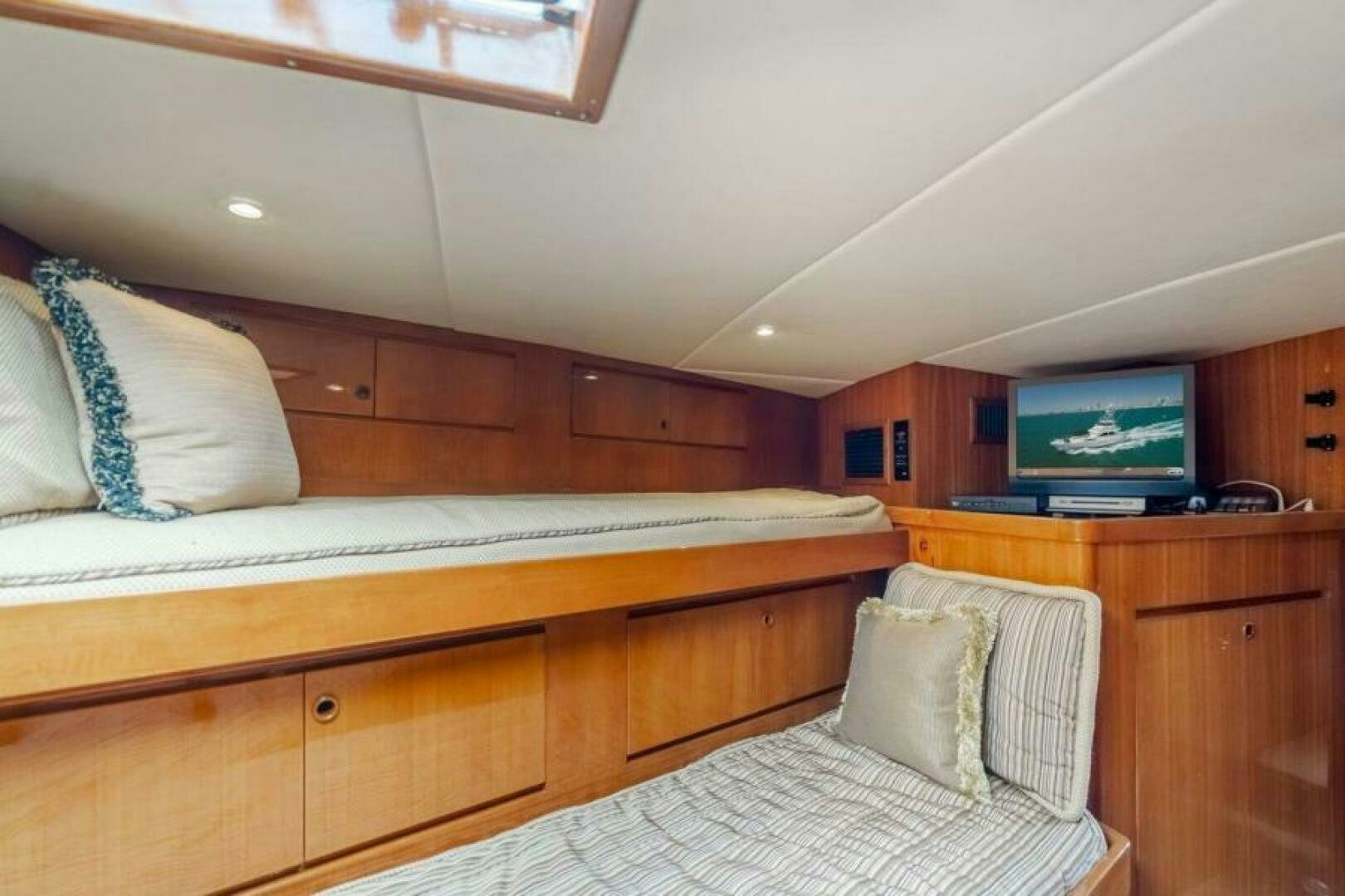 a bedroom with a bed and a television aboard FAN TAIL I Yacht for Sale