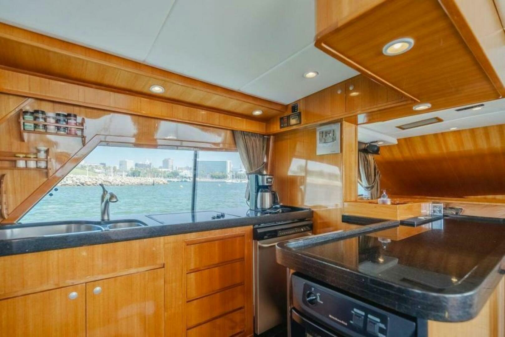a kitchen with wooden cabinets aboard FAN TAIL I Yacht for Sale
