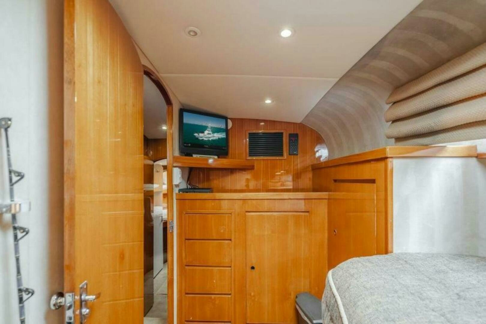a bedroom with a bed and a television aboard FAN TAIL I Yacht for Sale