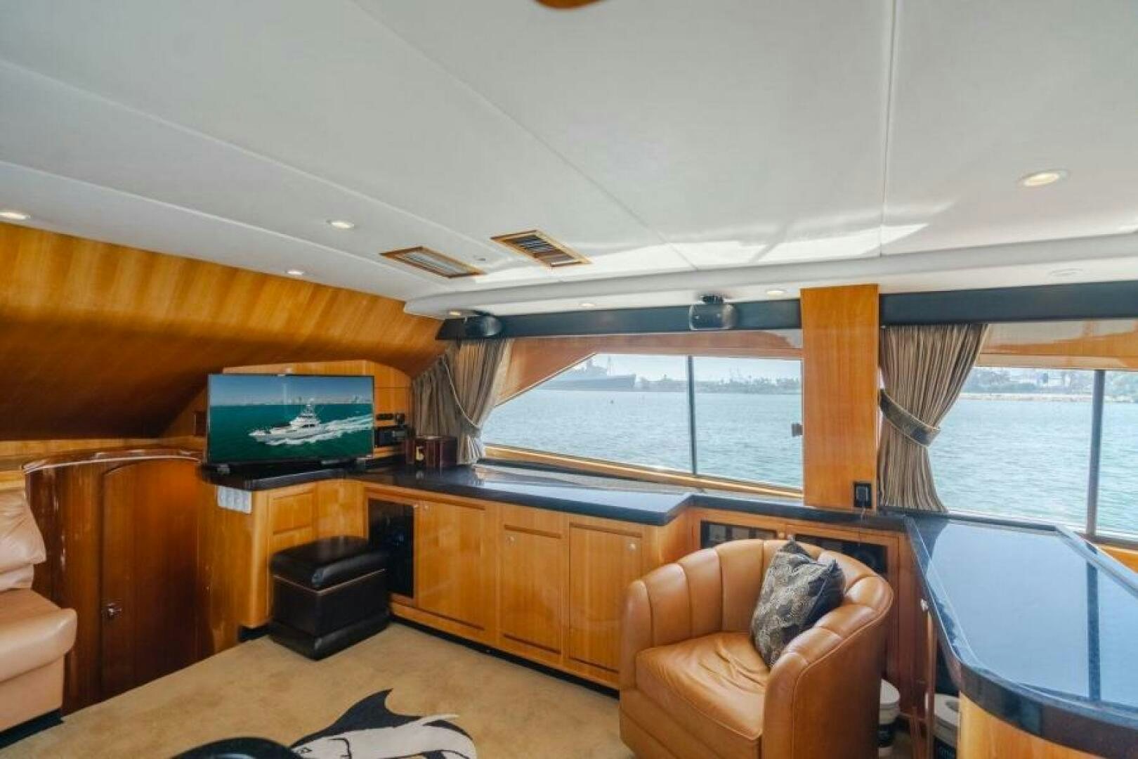 a living room with a tv and furniture aboard FAN TAIL I Yacht for Sale