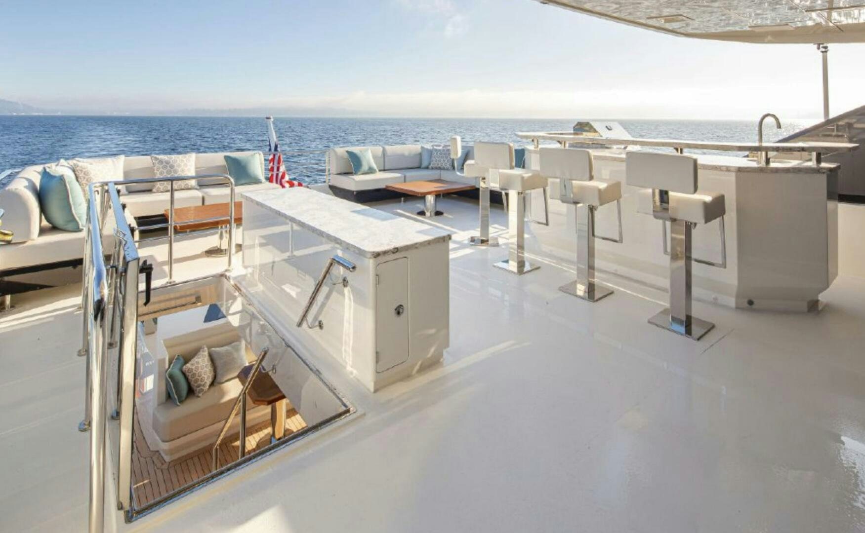 a deck with chairs and tables on it aboard TLC Yacht for Sale