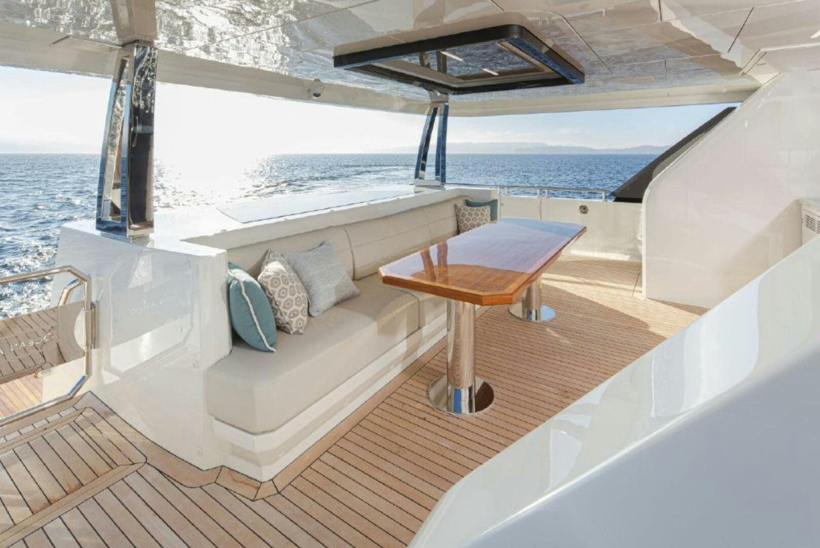a balcony with a table and chairs aboard TLC Yacht for Sale