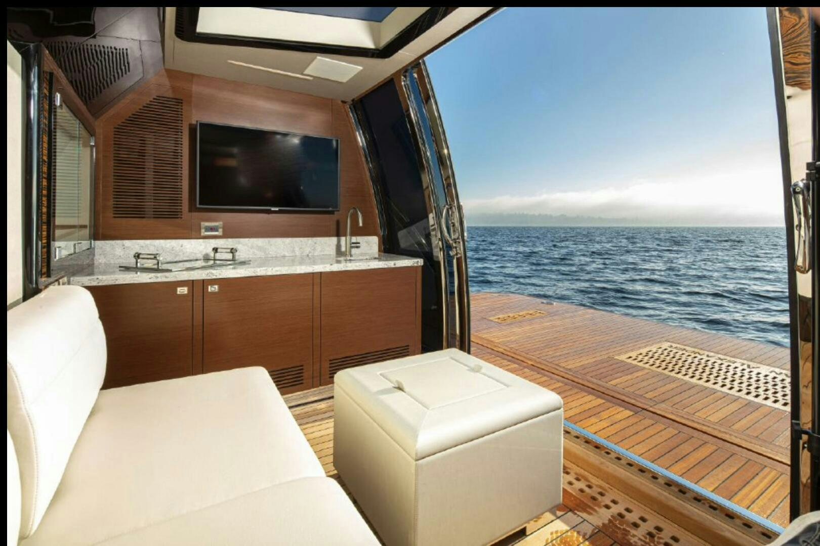 a boat with a large tv aboard TLC Yacht for Sale