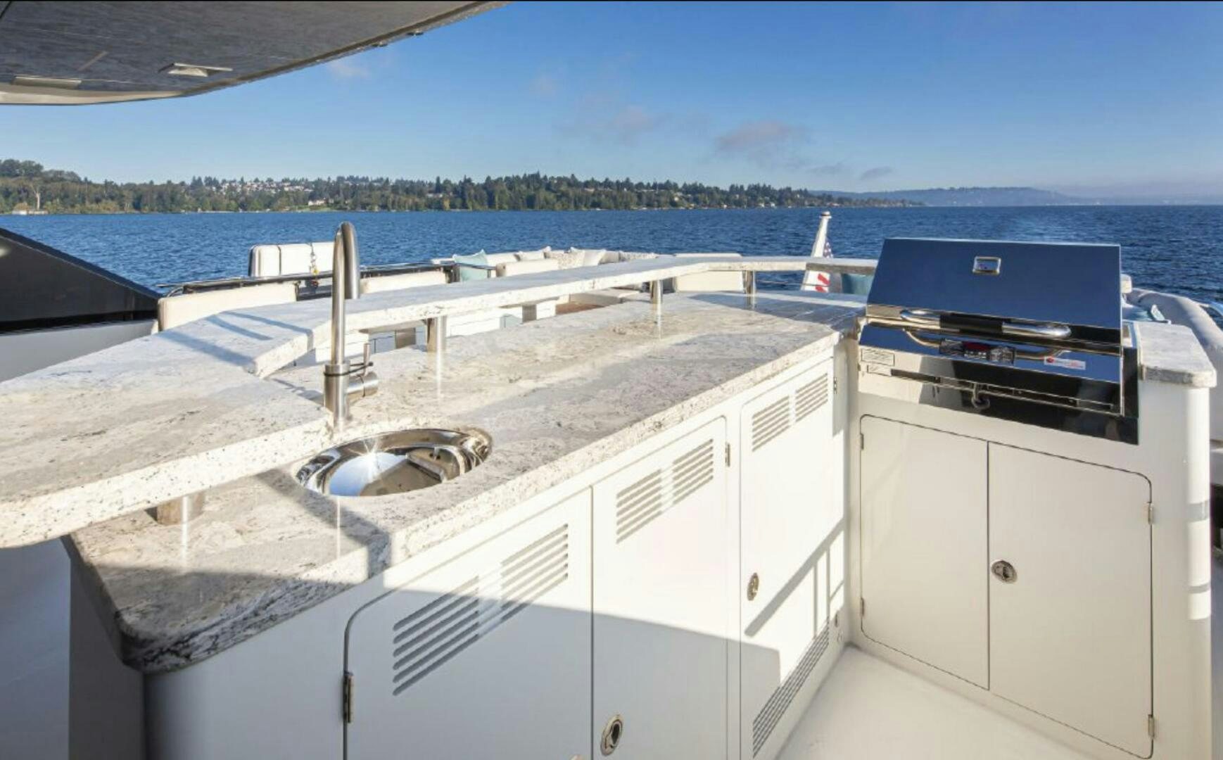 a large white boat on a deck aboard TLC Yacht for Sale