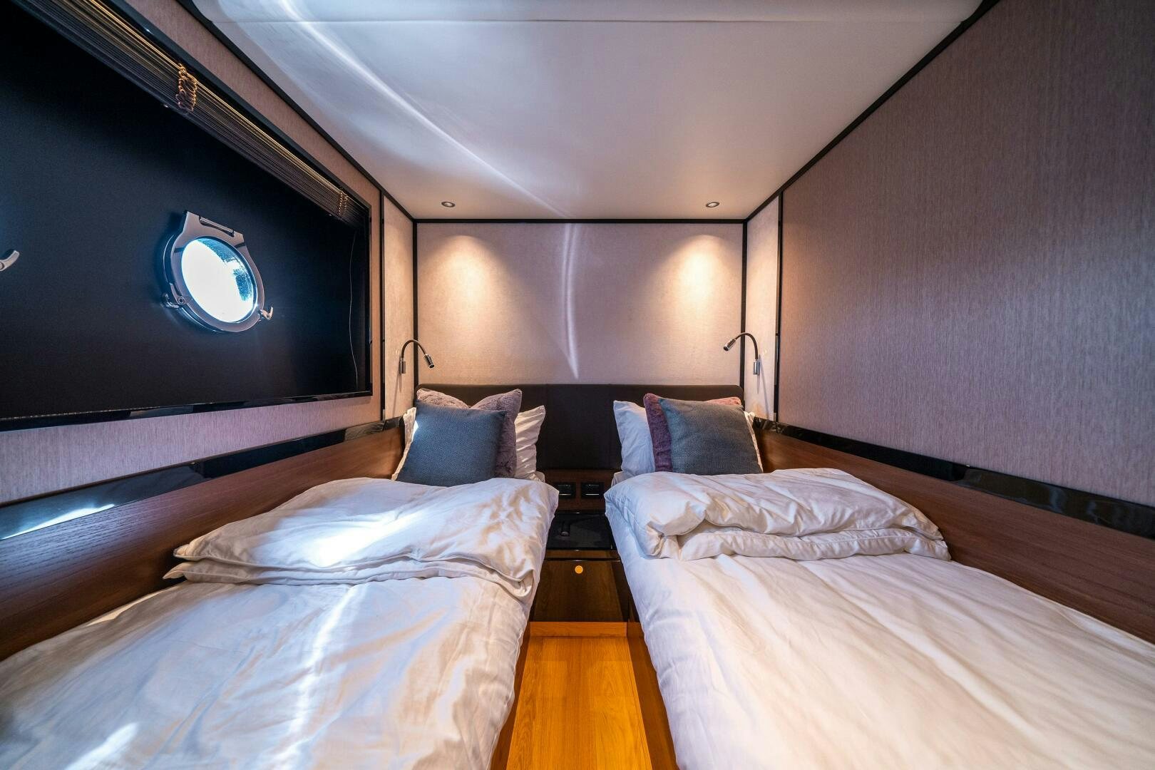 a room with a bed and a tv on the wall aboard ALGI Yacht for Sale