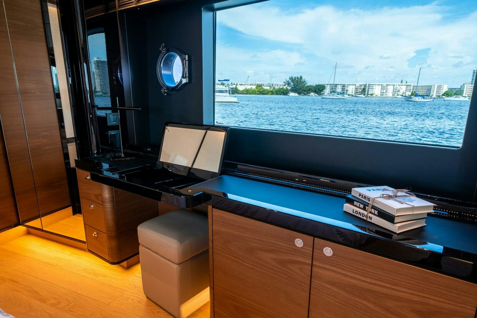 a room with a large window and a desk with a laptop aboard ALGI Yacht for Sale
