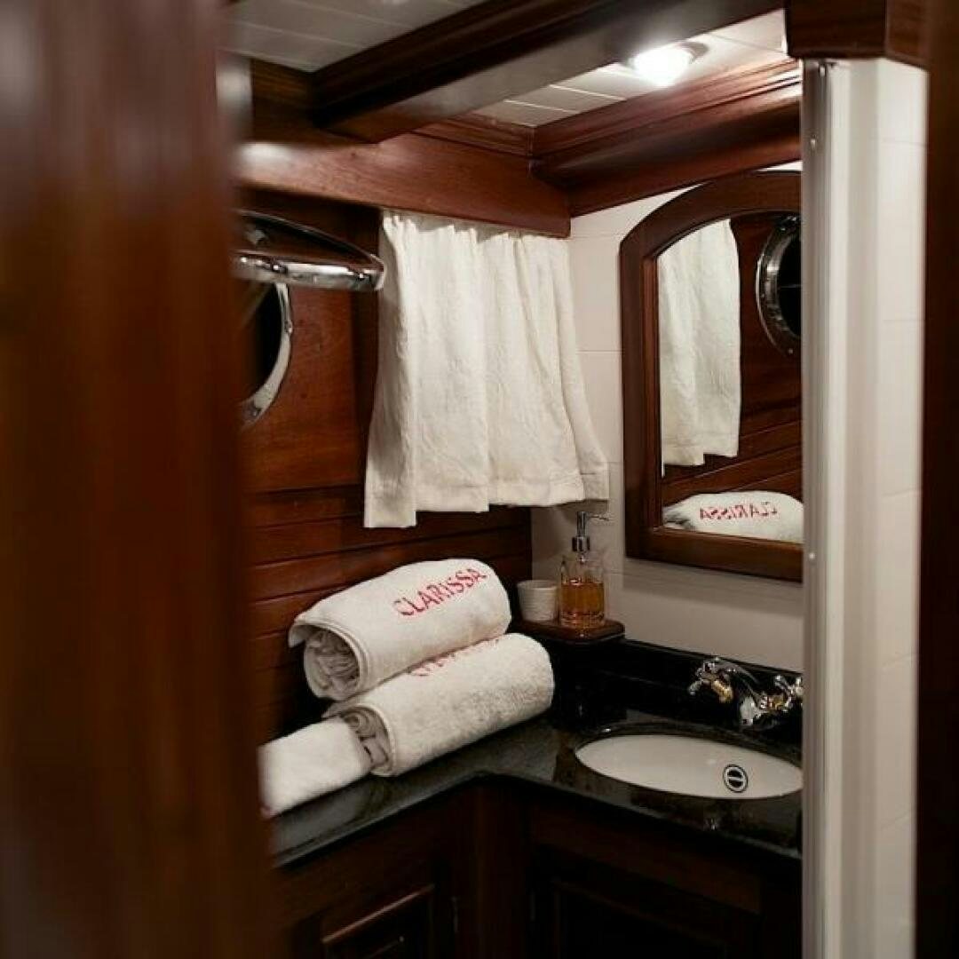 a bathroom with a sink and mirror aboard CLARISSA Yacht for Sale