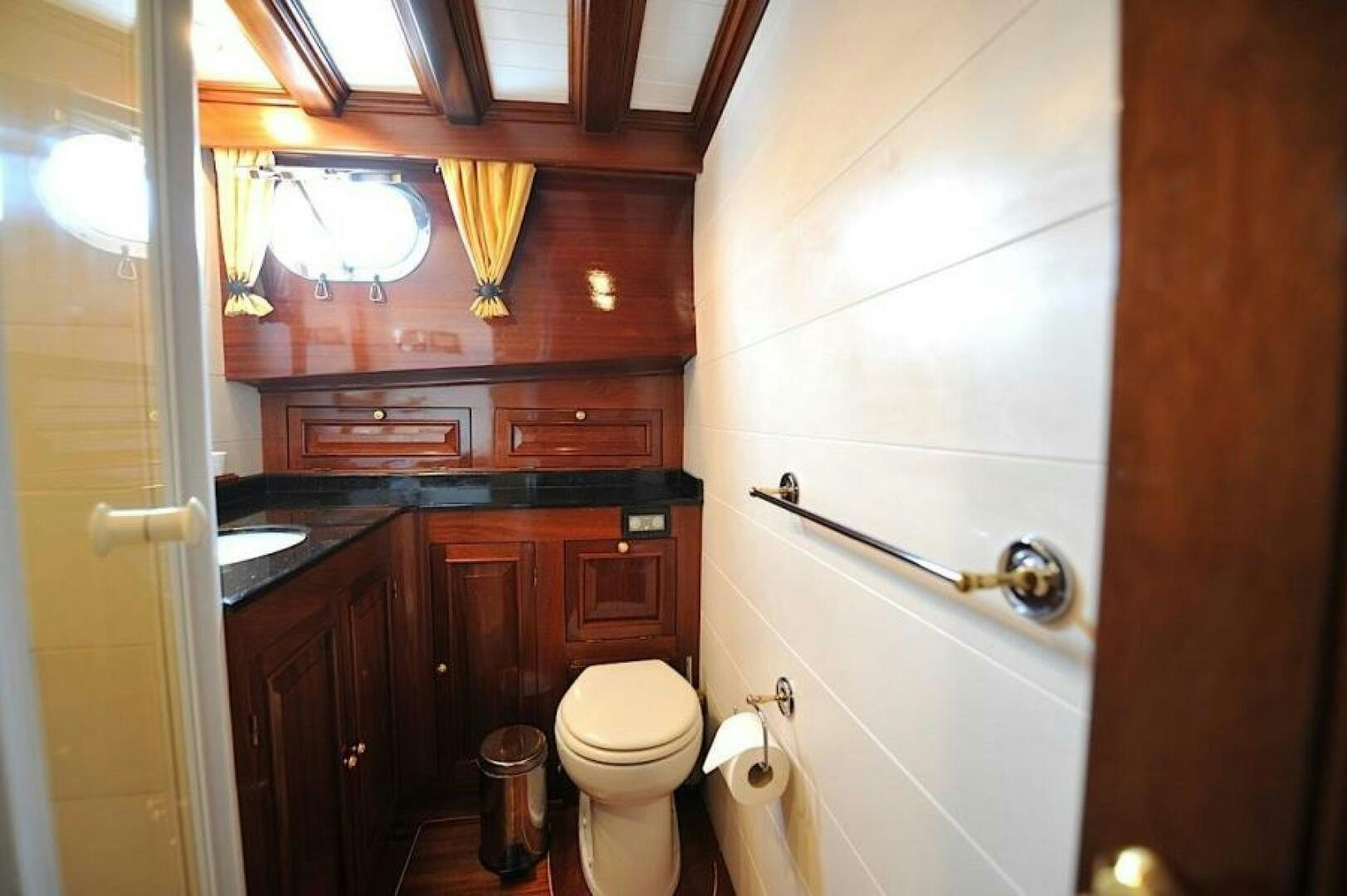 a bathroom with a toilet and a sink aboard CLARISSA Yacht for Sale