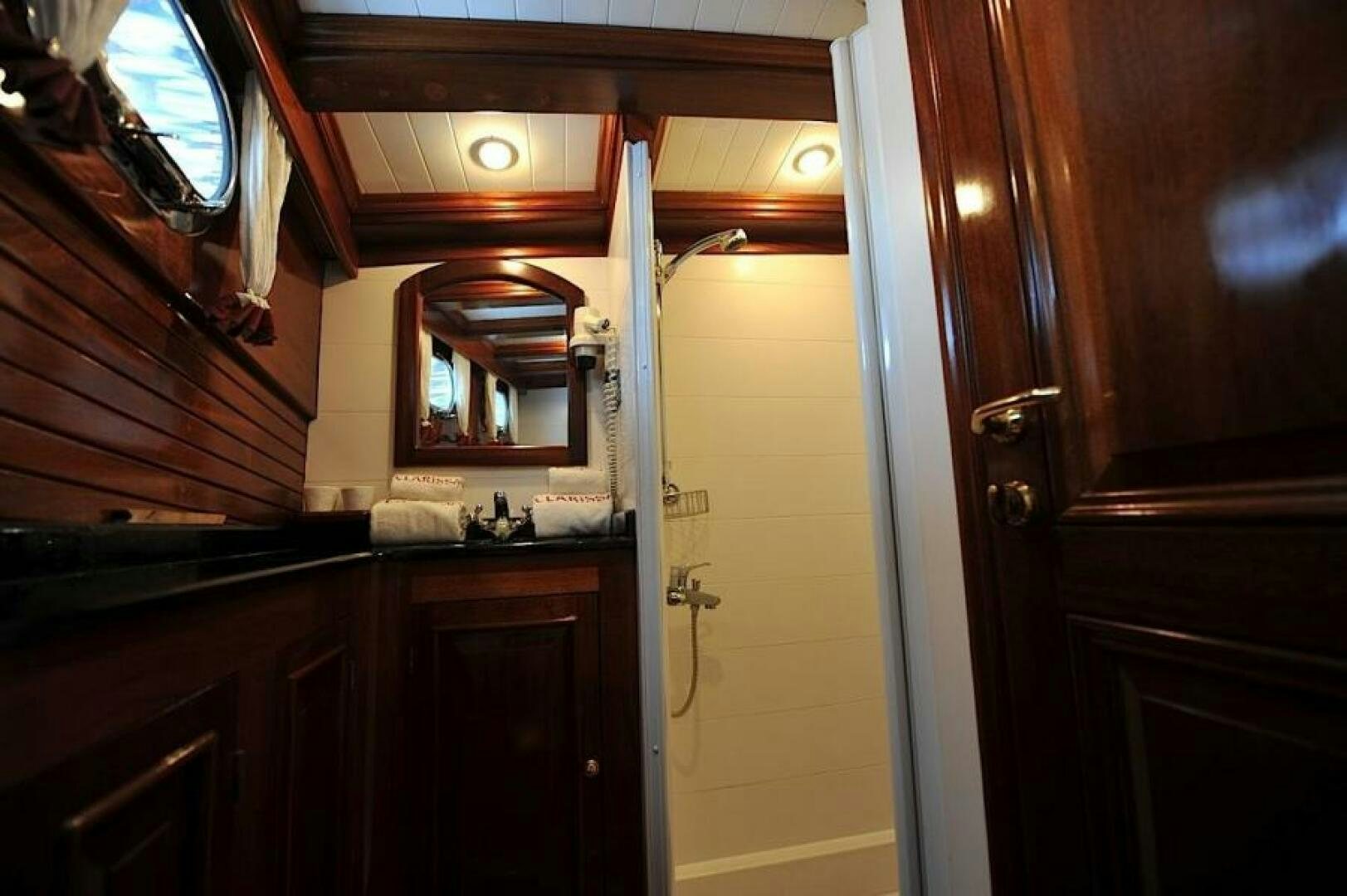 a bathroom with a mirror and a sink aboard CLARISSA Yacht for Sale