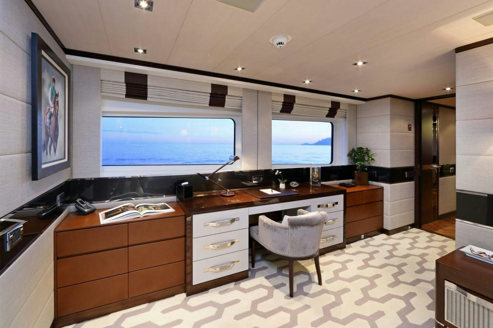 a room with a desk and a tv aboard AURELIA Yacht for Sale