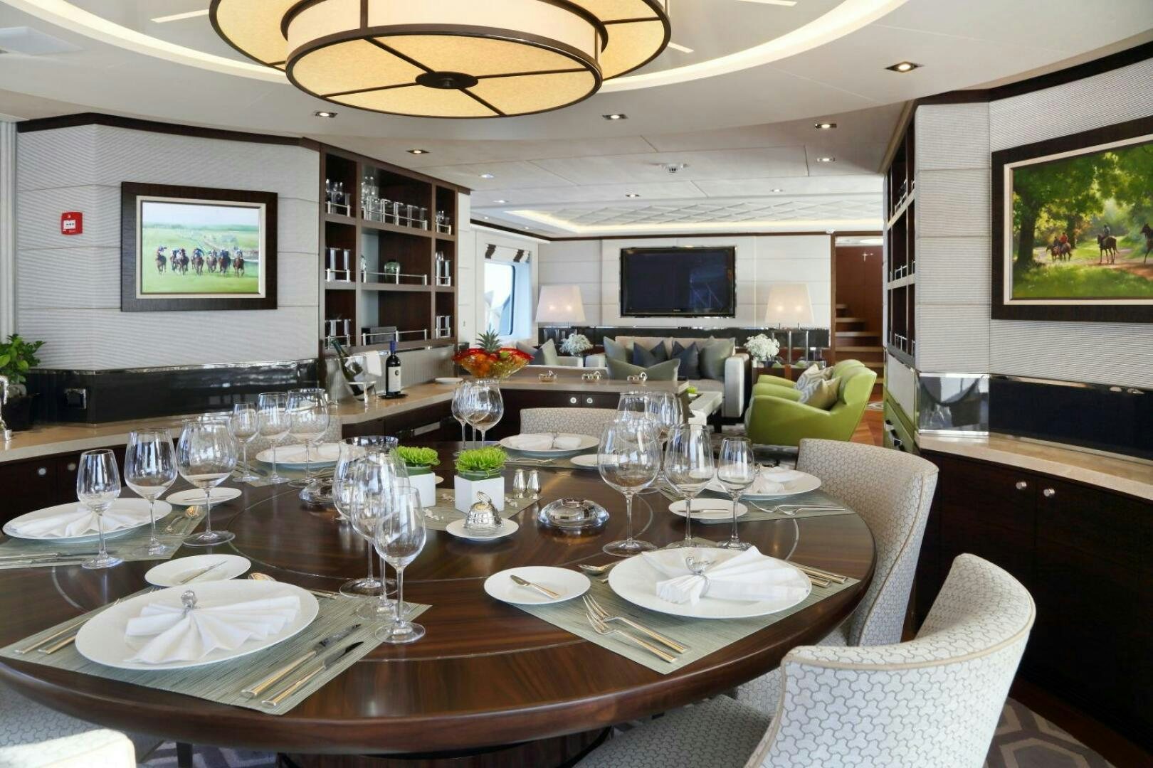 a large dining table with wine glasses aboard AURELIA Yacht for Sale