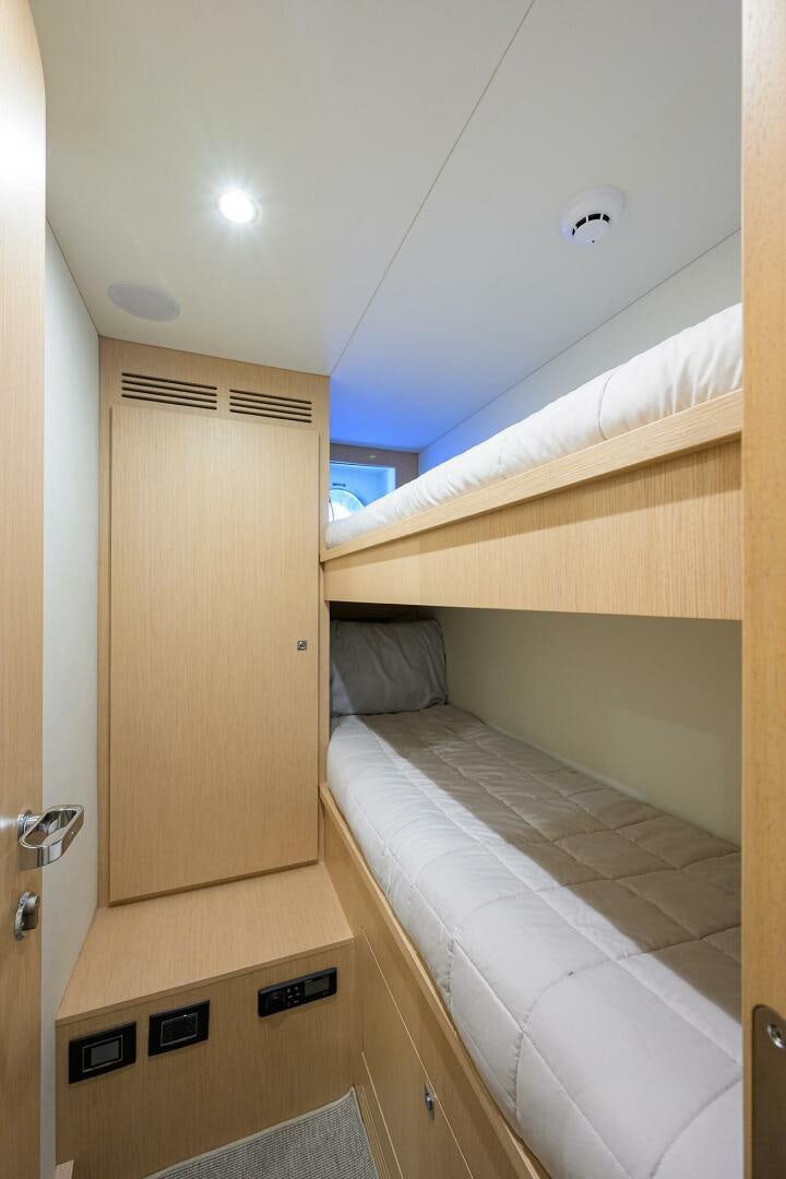 a room with a bed and a door aboard RISE ABOVE III Yacht for Sale