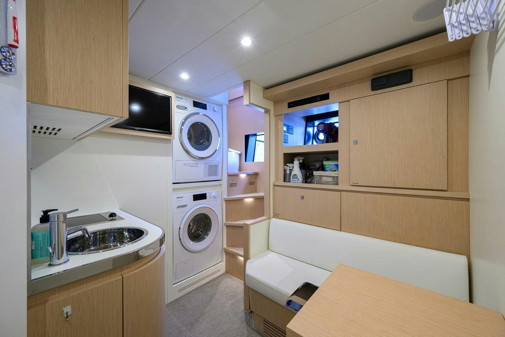 a small kitchen with a bed and a microwave aboard RISE ABOVE III Yacht for Sale