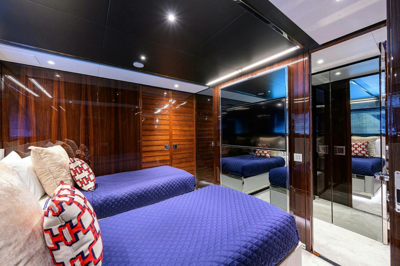 a room with a bed and a glass door aboard RISE ABOVE III Yacht for Sale