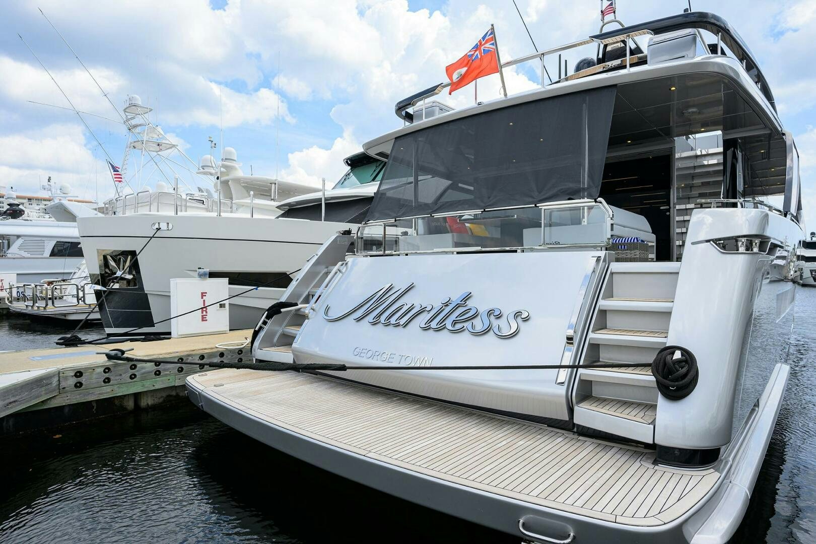 a white boat on a dock aboard RISE ABOVE III Yacht for Sale