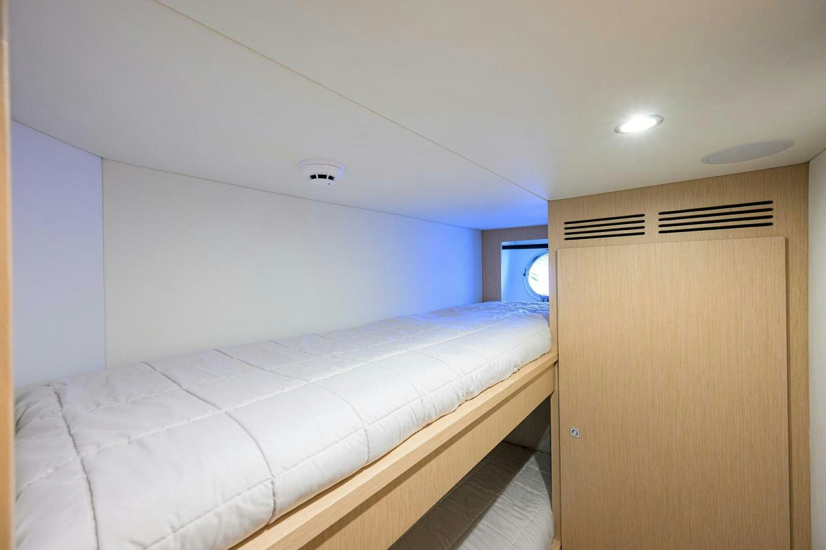 a room with a bed and a window aboard RISE ABOVE III Yacht for Sale