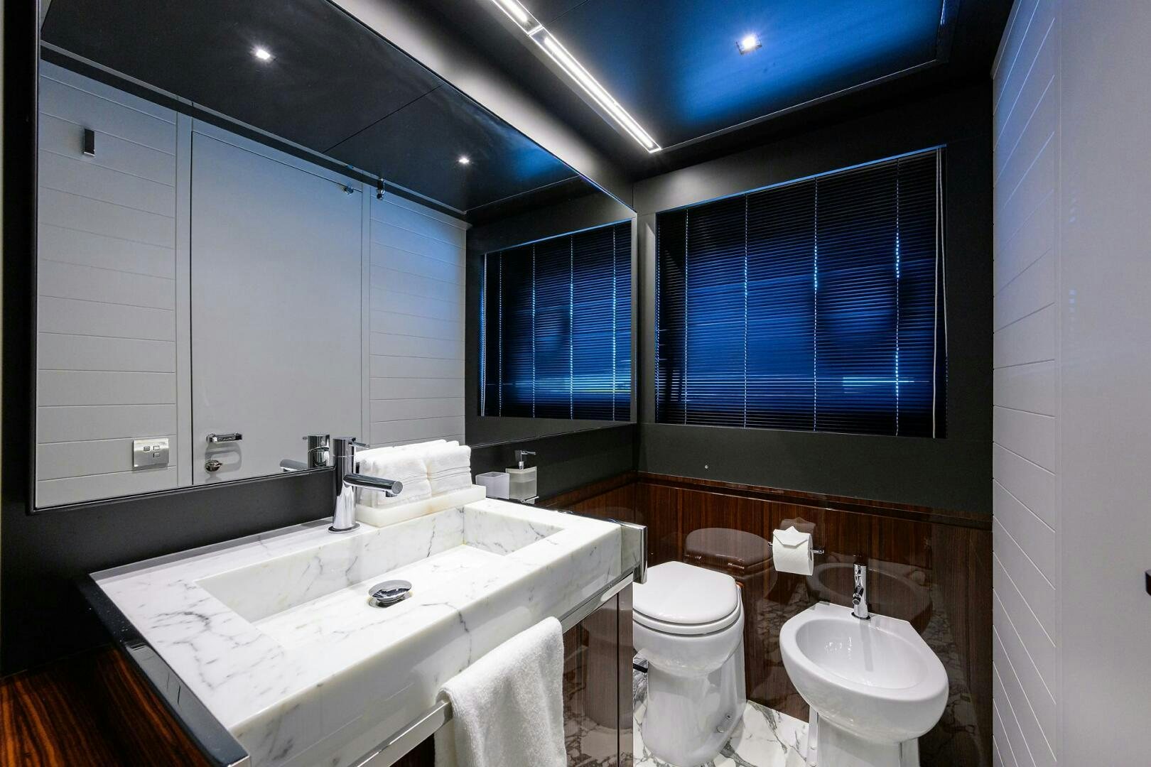 a bathroom with a sink and a toilet aboard RISE ABOVE III Yacht for Sale