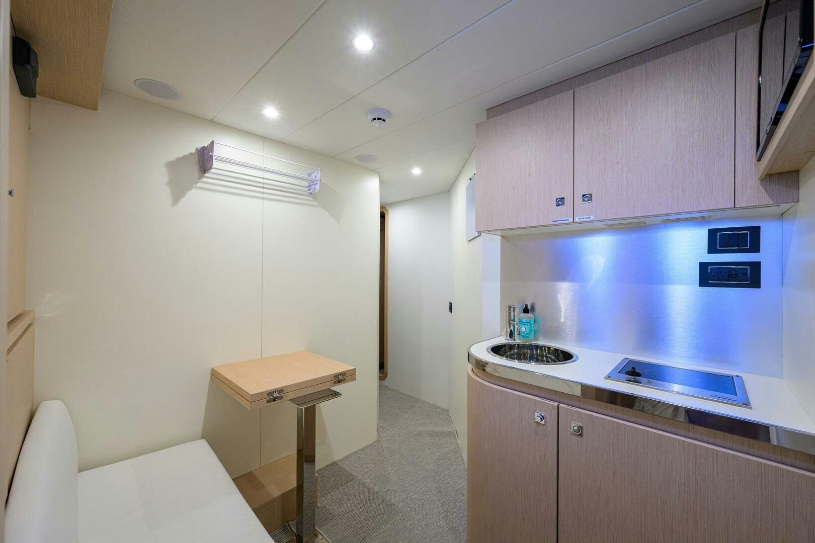 a kitchen with a sink and a table aboard RISE ABOVE III Yacht for Sale