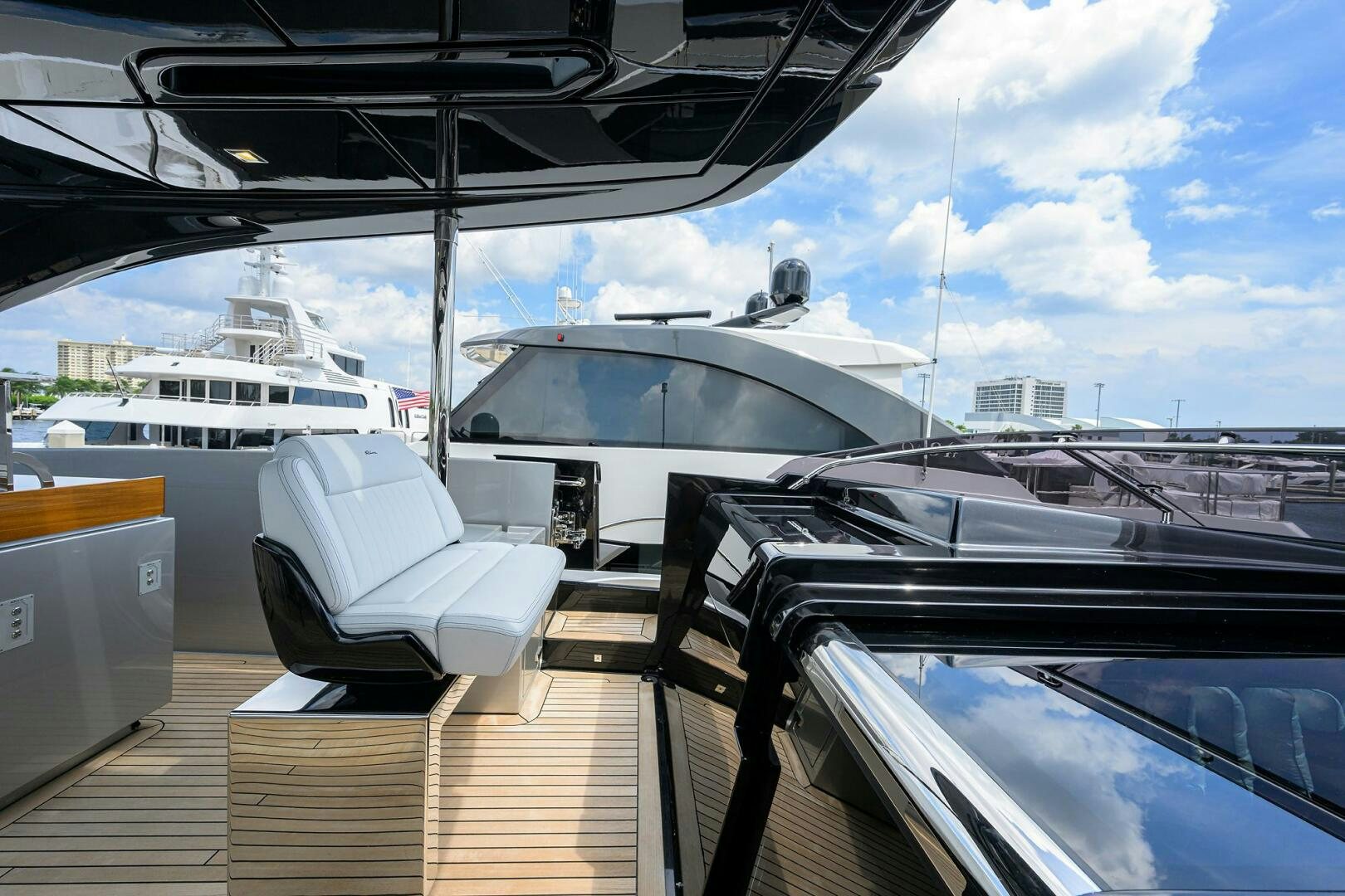 a deck with a chair and a boat on it aboard RISE ABOVE III Yacht for Sale