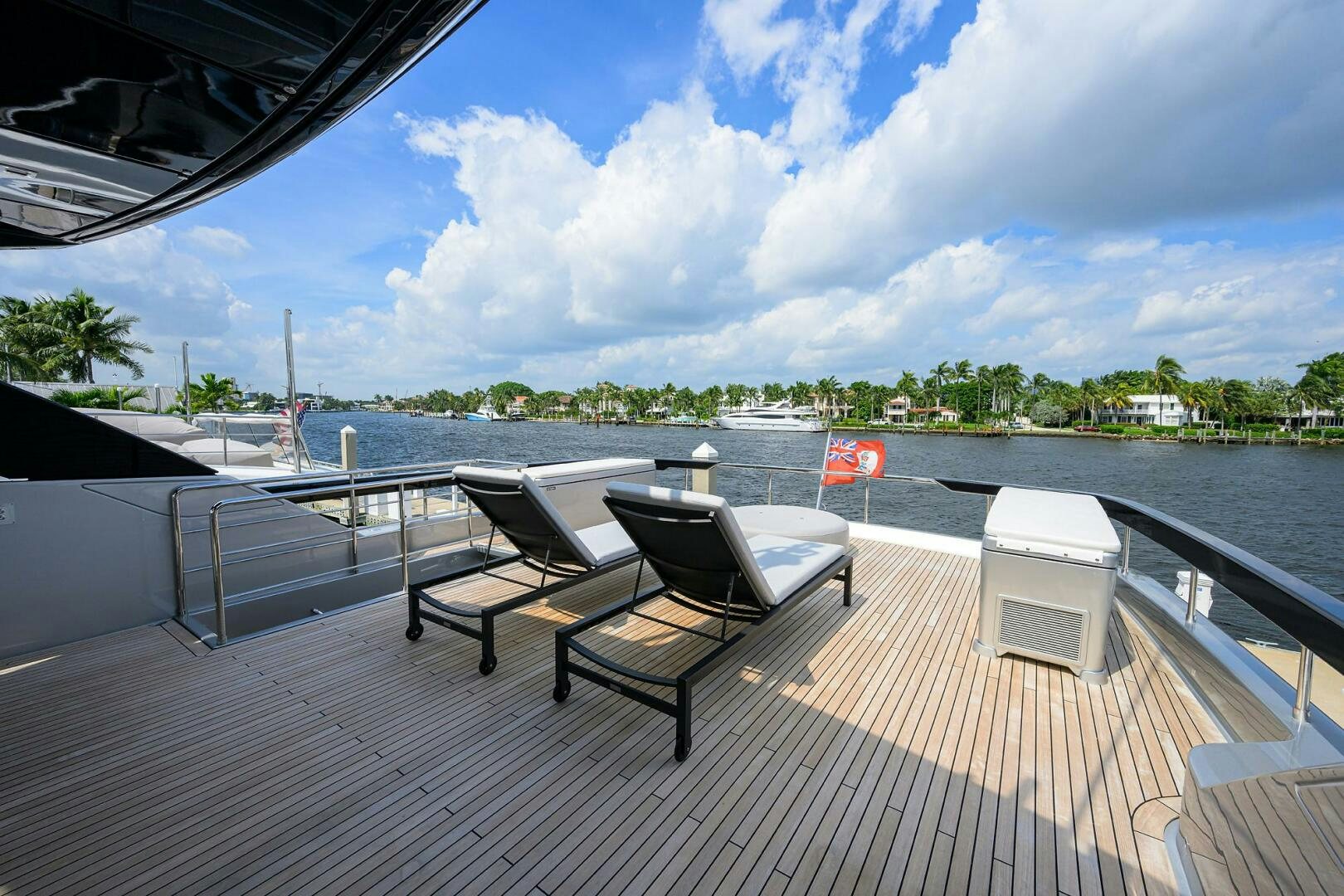 a deck with chairs and a body of water in the background aboard RISE ABOVE III Yacht for Sale