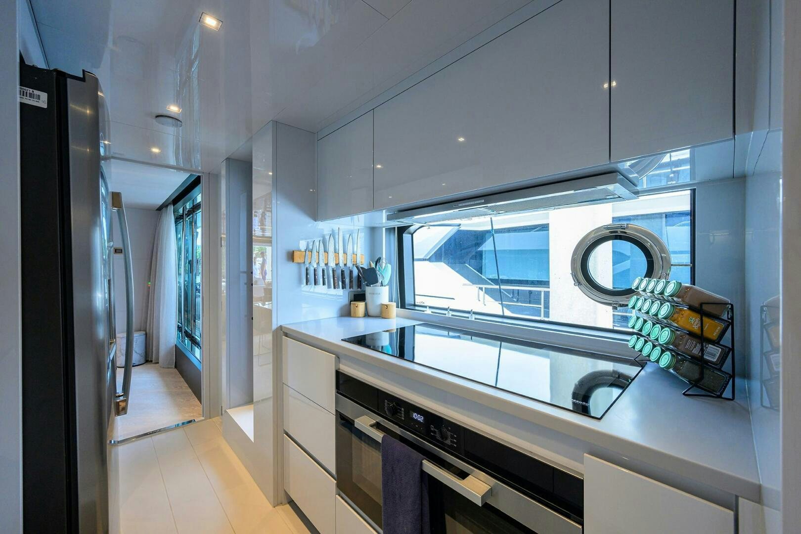 a kitchen with a large window aboard RISE ABOVE III Yacht for Sale