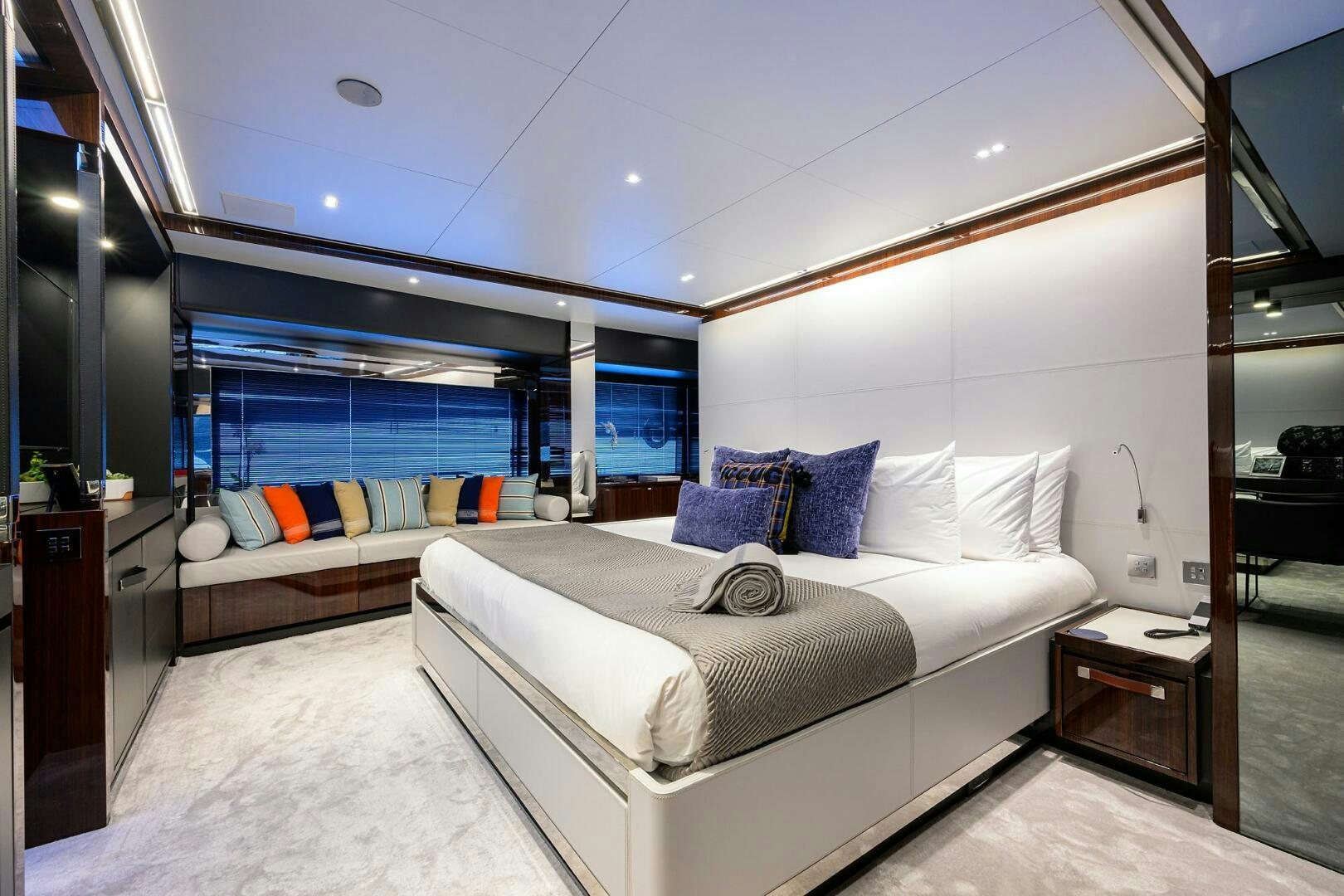 a bedroom with a bed and a desk aboard RISE ABOVE III Yacht for Sale