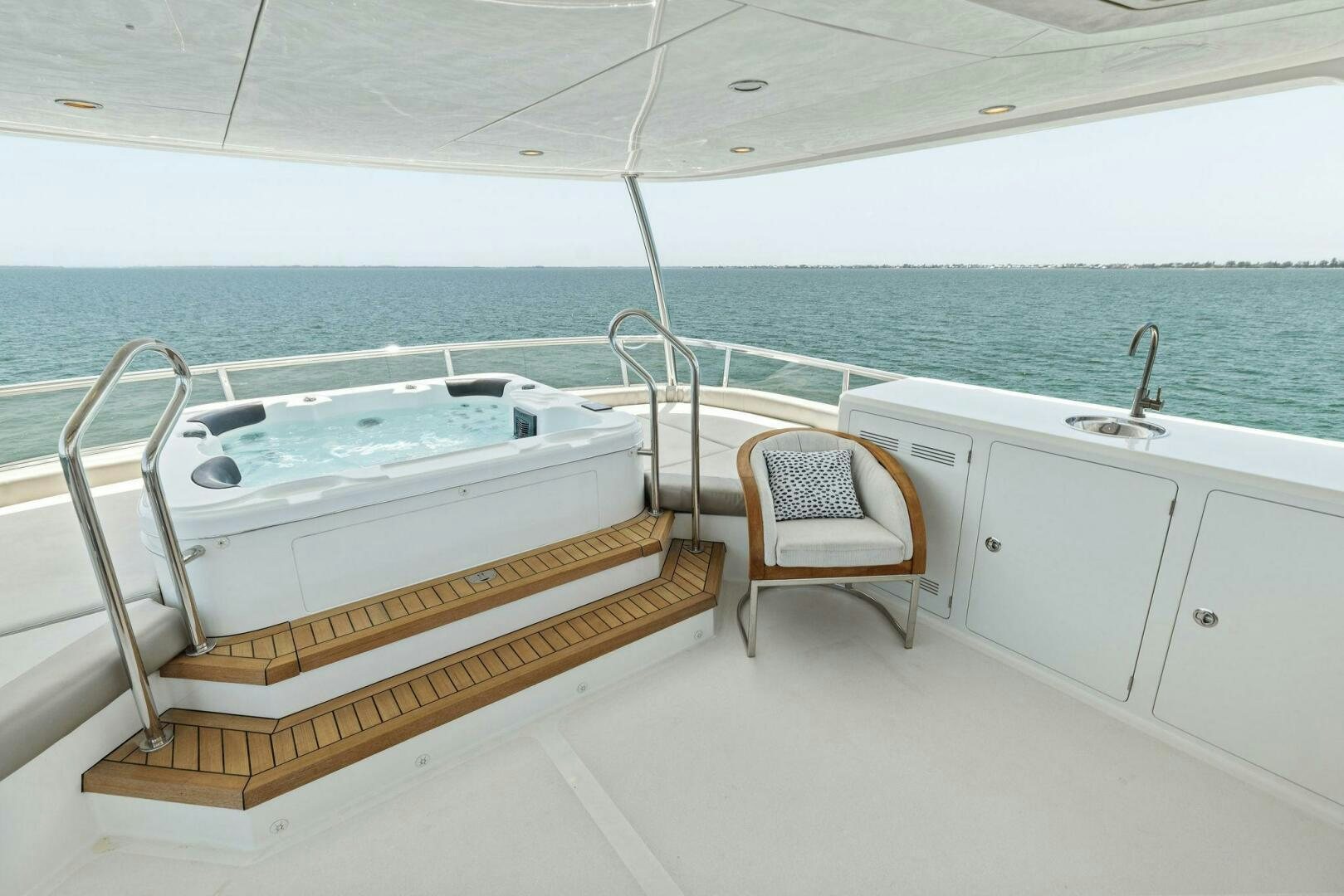 a white bathtub and a chair on a boat in the water aboard SUNZSET Yacht for Sale