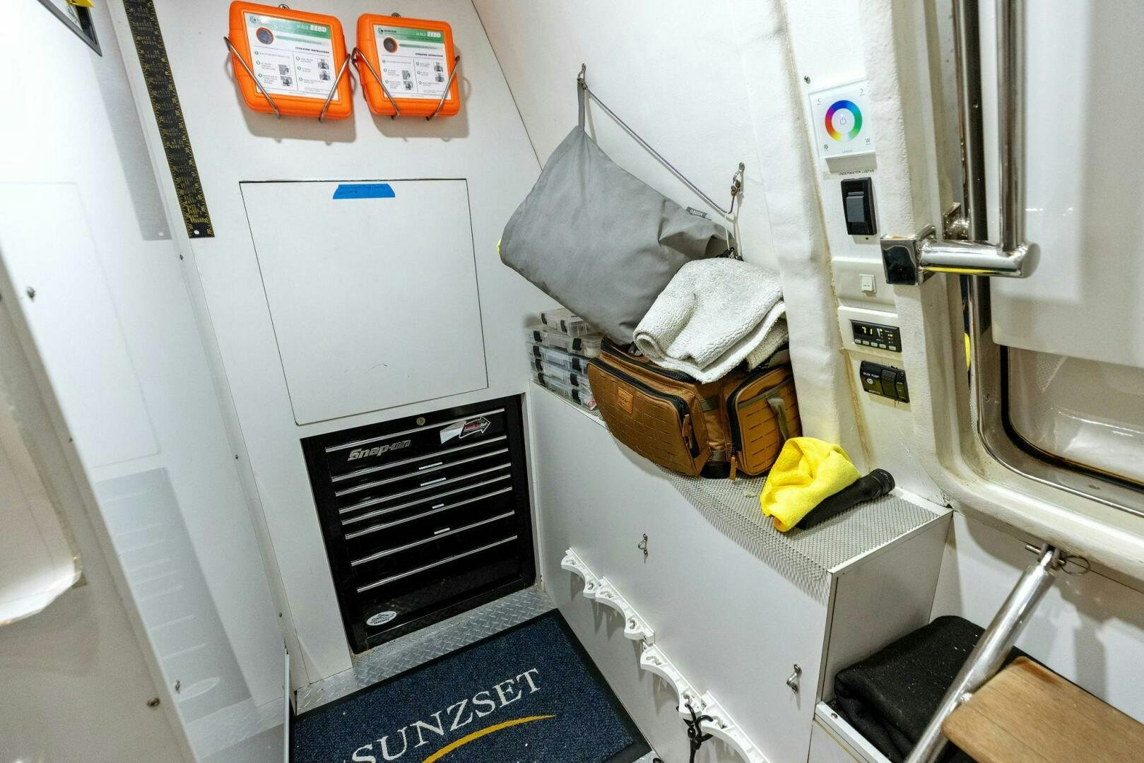 a laundry machine with clothes on the wall aboard SUNZSET Yacht for Sale