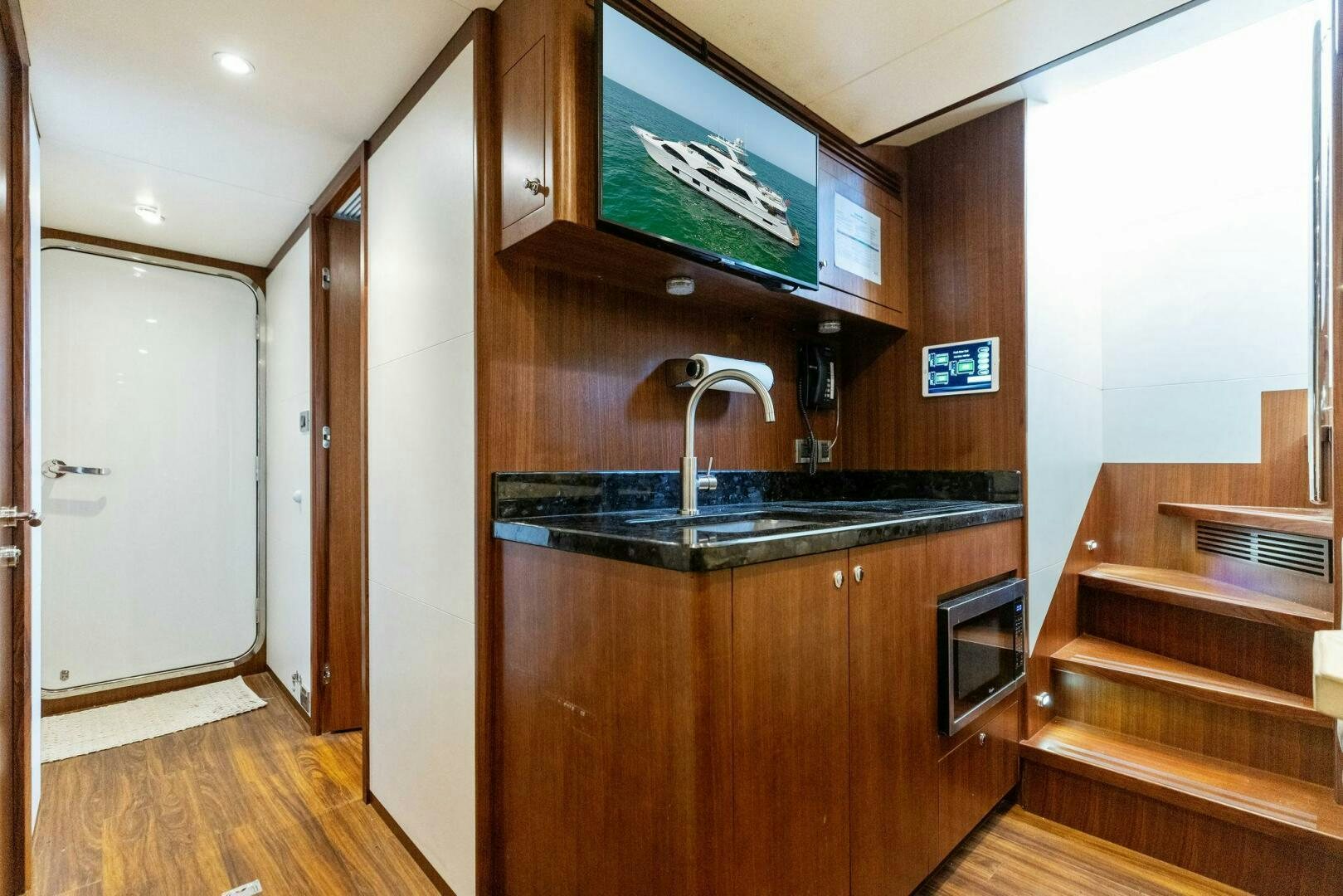 a kitchen with a large tv aboard SUNZSET Yacht for Sale