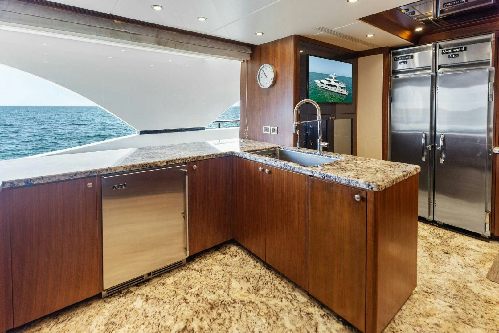 a kitchen with a large island aboard SUNZSET Yacht for Sale