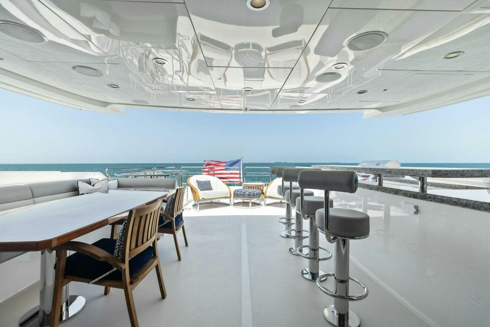 a room with tables and chairs aboard SUNZSET Yacht for Sale