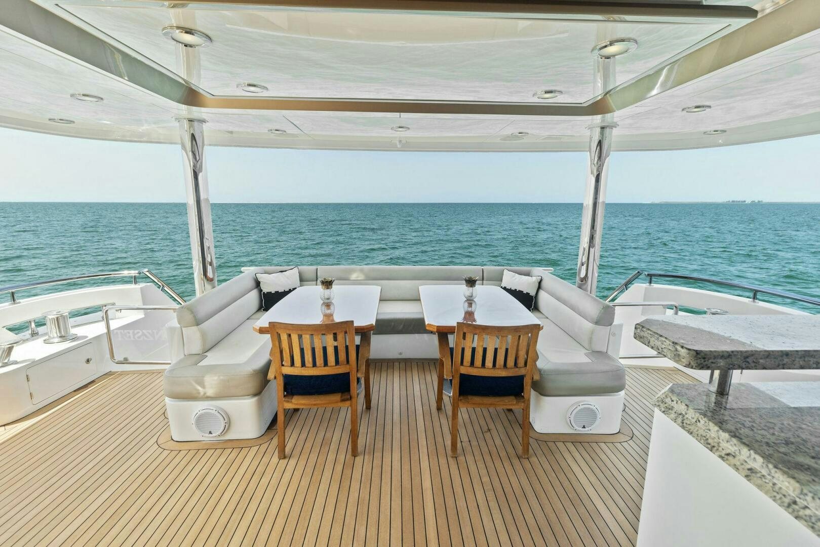 a table and chairs on a deck aboard SUNZSET Yacht for Sale