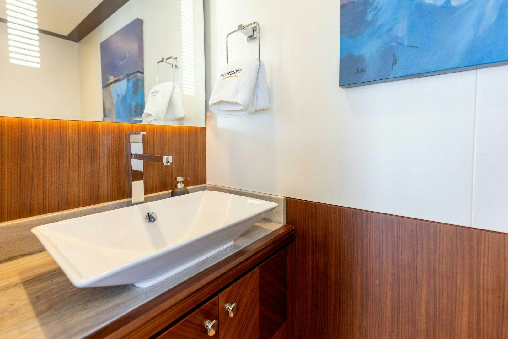 a bathroom with a sink and a mirror aboard SUNZSET Yacht for Sale