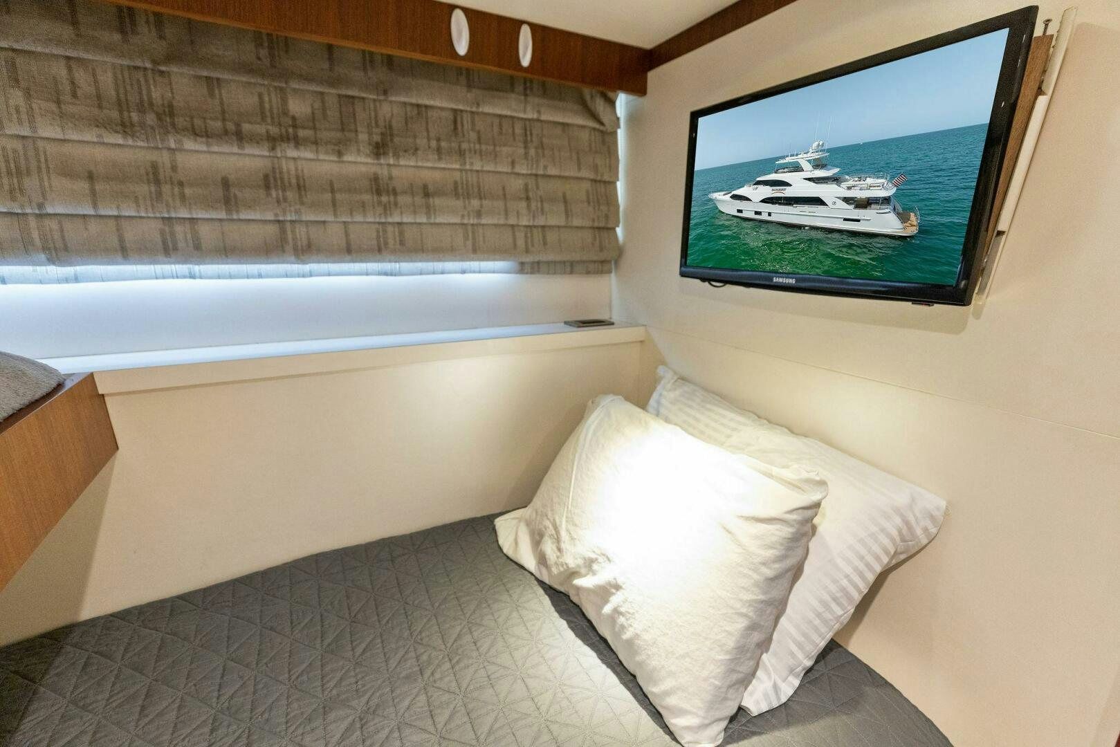 a bed and a television in a room aboard SUNZSET Yacht for Sale