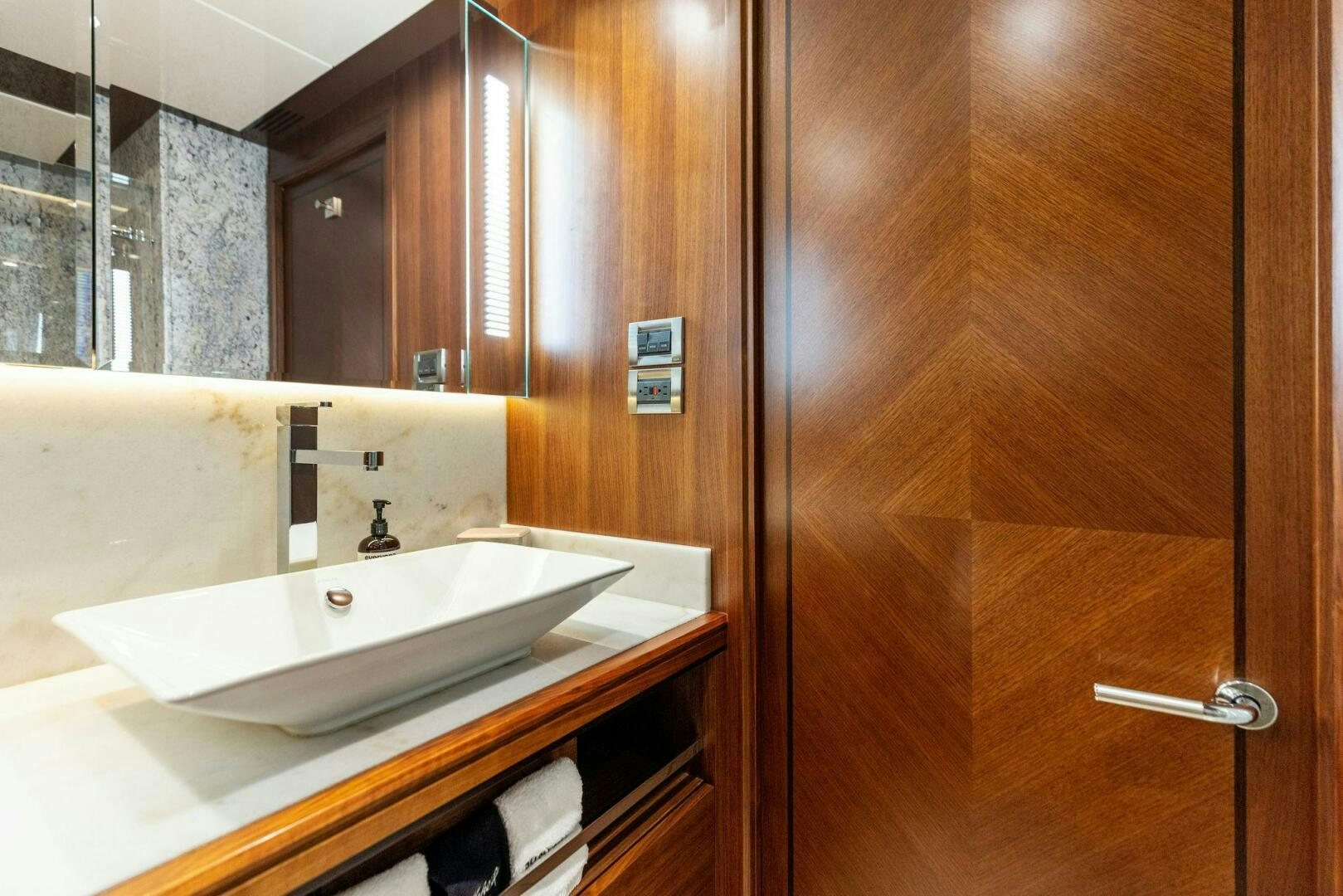 a bathroom with a sink and a mirror aboard SUNZSET Yacht for Sale