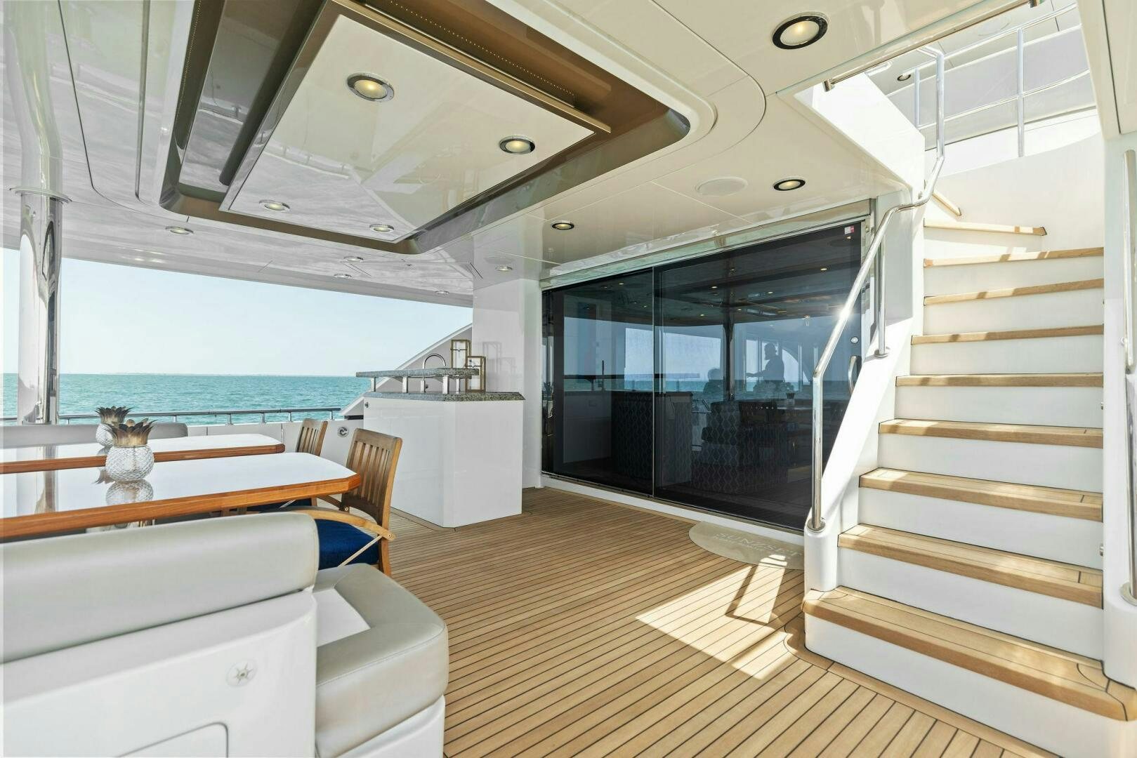 a modern looking room with a large open door aboard SUNZSET Yacht for Sale