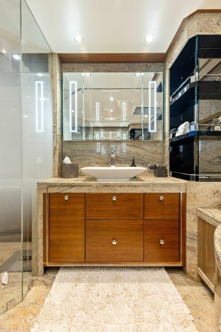 a bathroom with a large mirror aboard SUNZSET Yacht for Sale