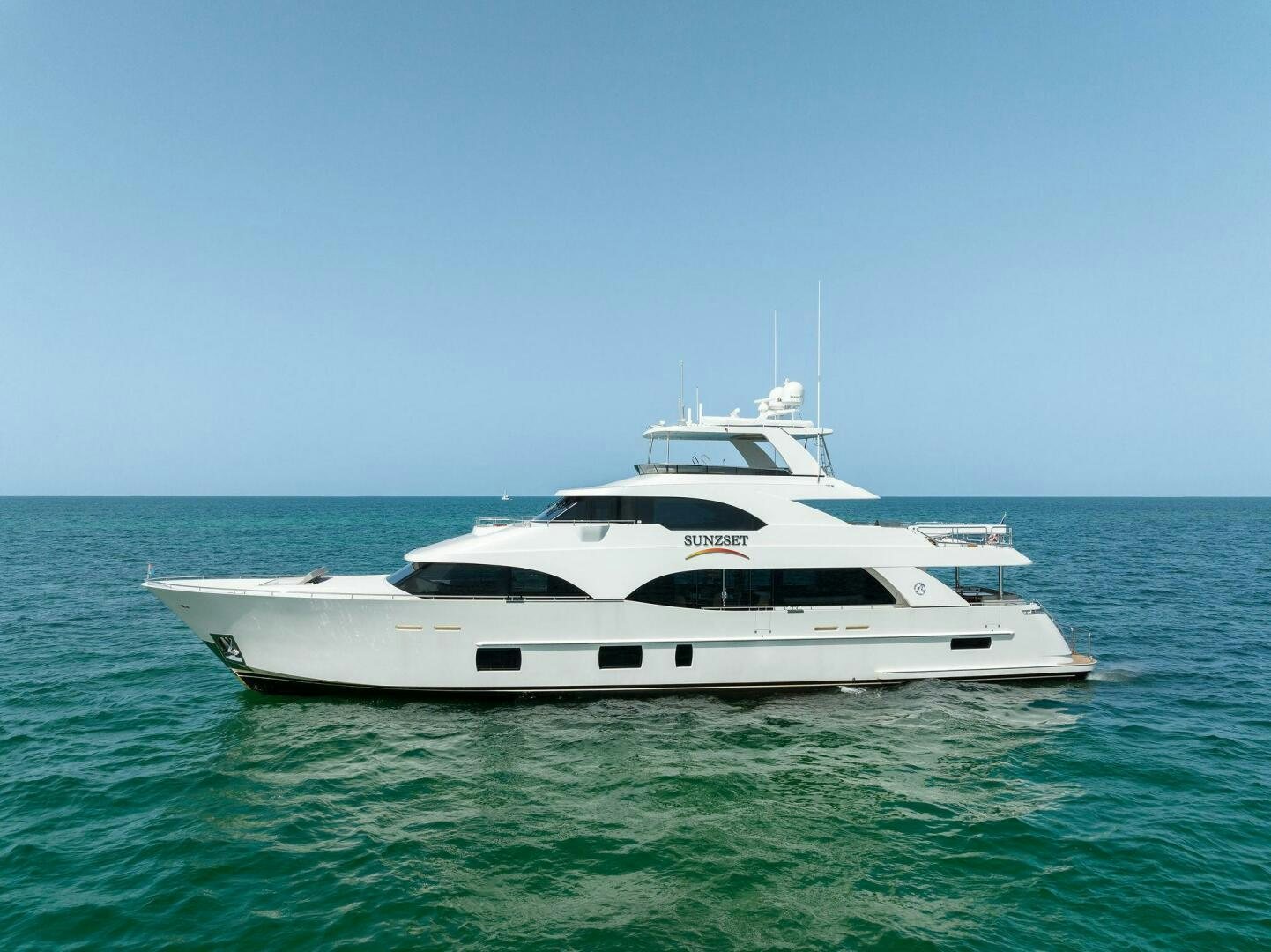 a white yacht in the water aboard SUNZSET Yacht for Sale