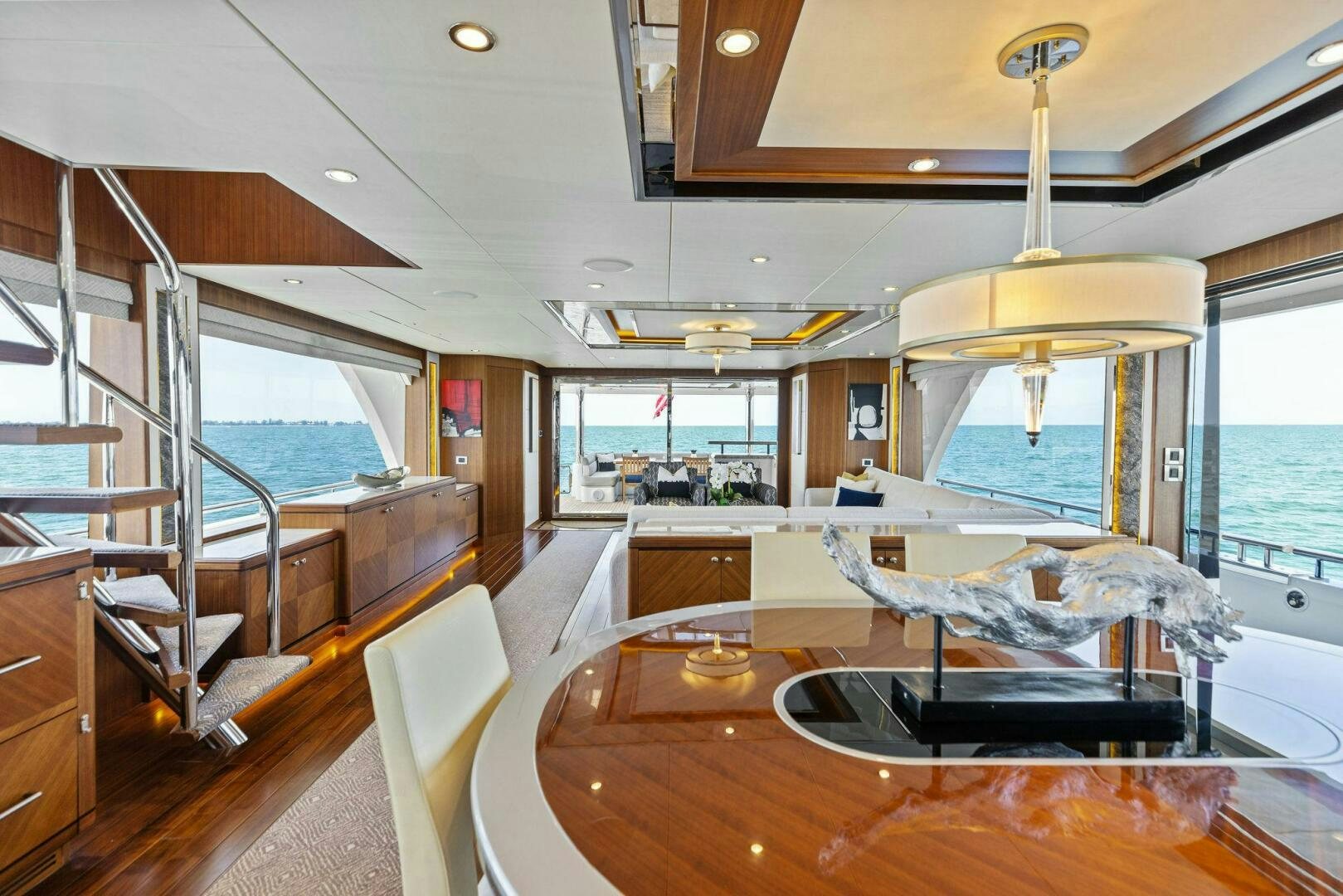 a large living room with a large window and a view of the water aboard SUNZSET Yacht for Sale