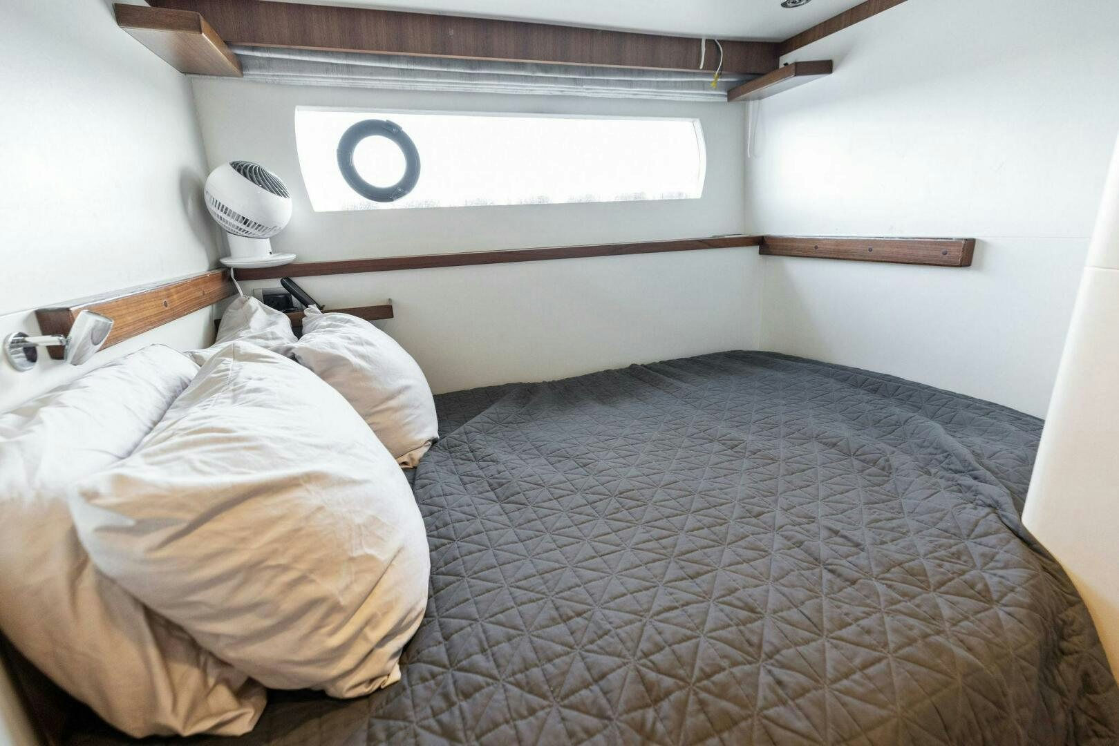 a bed with a white bed spread aboard SUNZSET Yacht for Sale