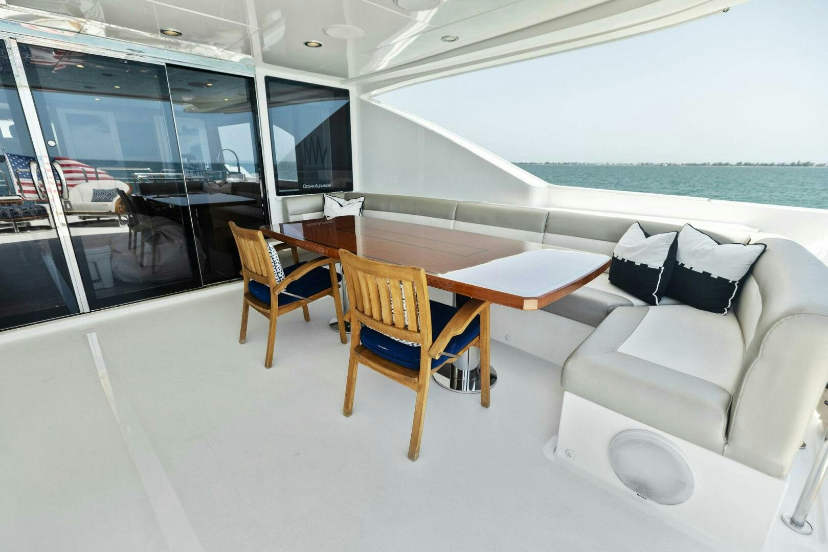 a room with a couch and a table and chairs aboard SUNZSET Yacht for Sale