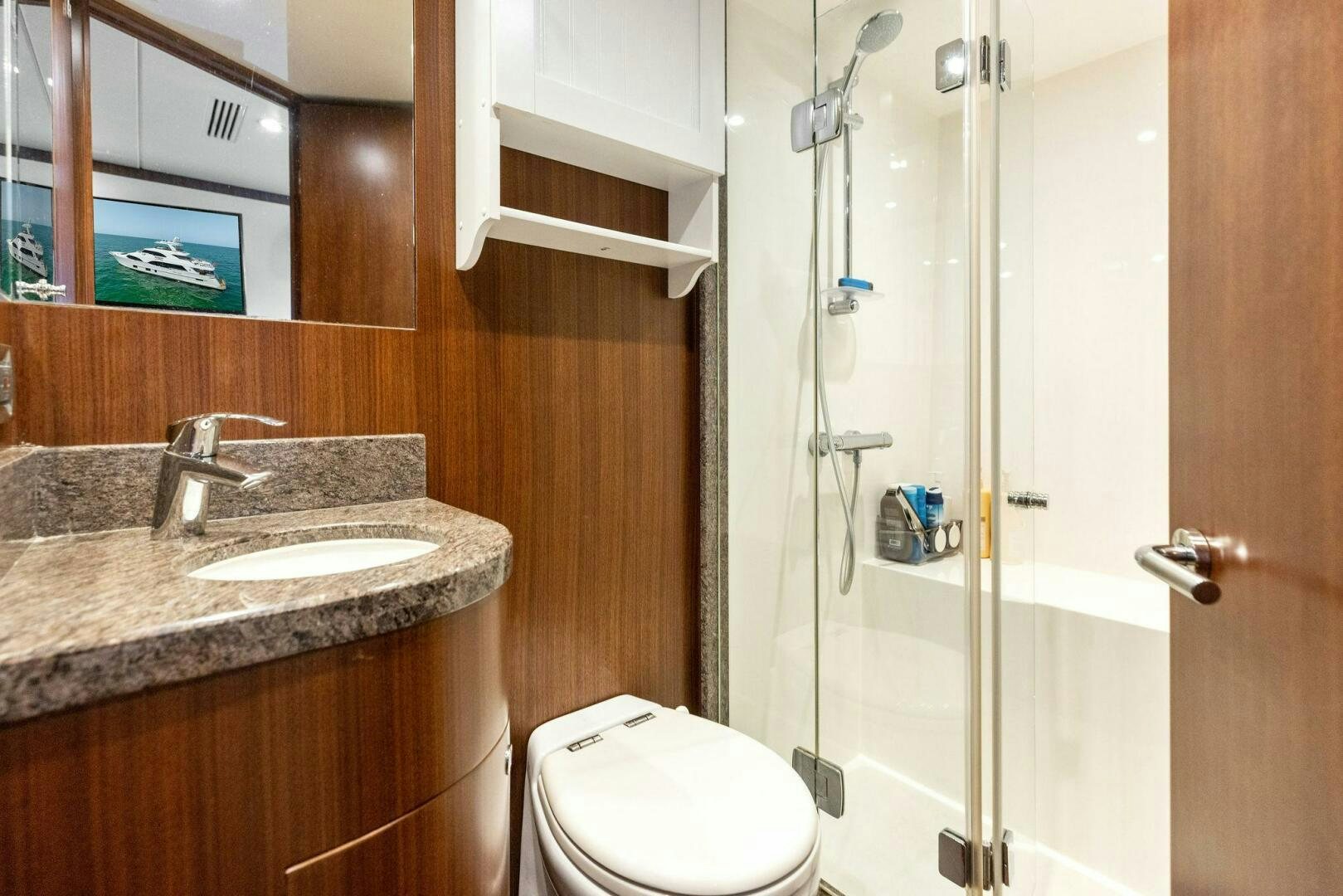 a bathroom with a glass shower door aboard SUNZSET Yacht for Sale