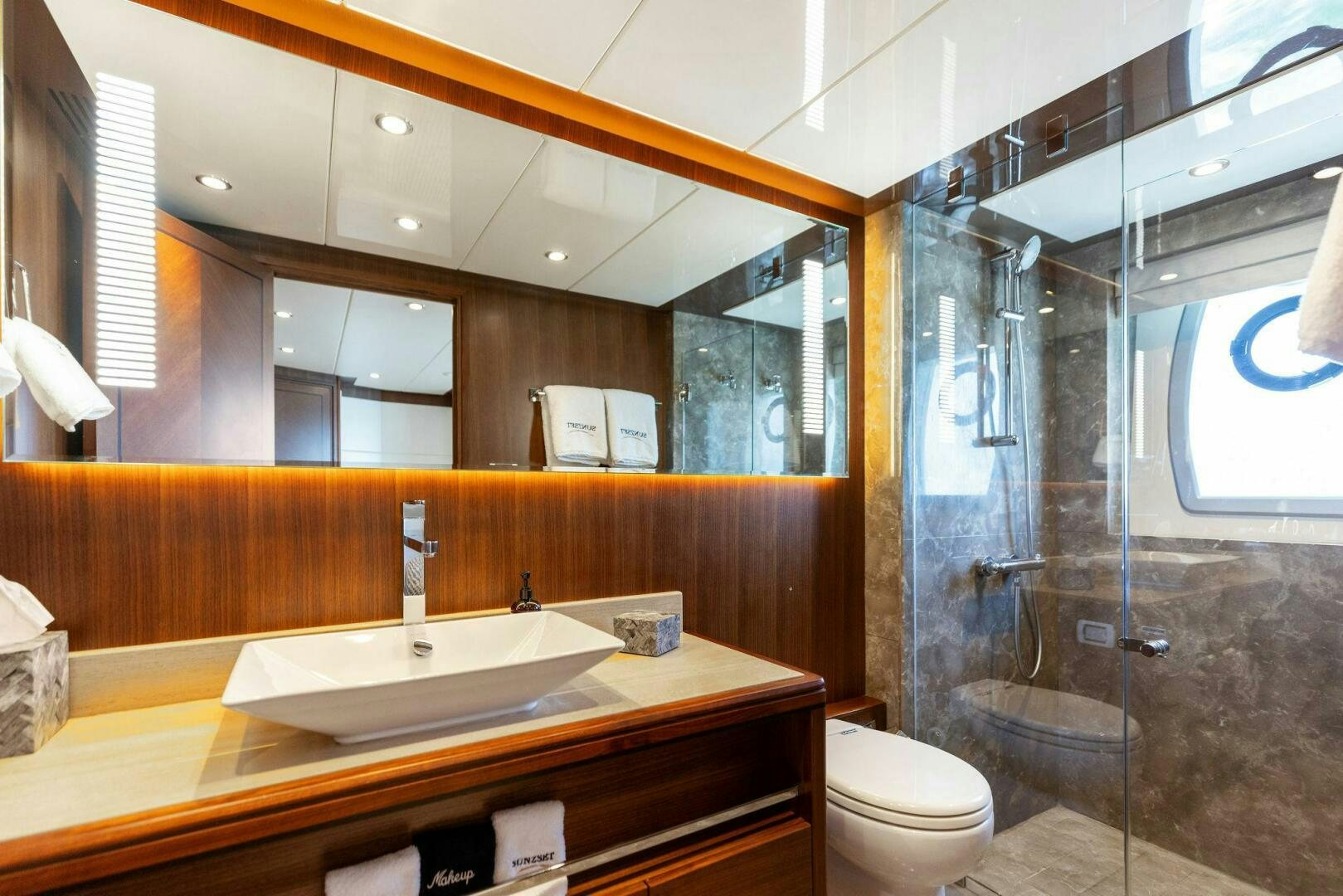 a bathroom with a glass shower aboard SUNZSET Yacht for Sale