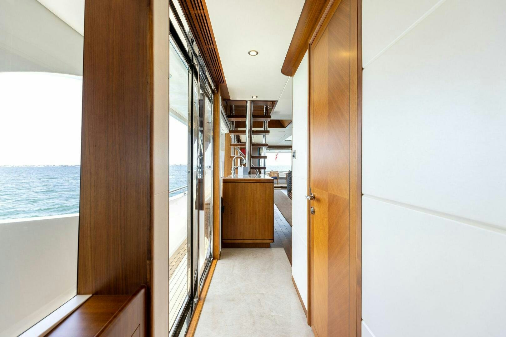 a room with a door and a balcony aboard SUNZSET Yacht for Sale