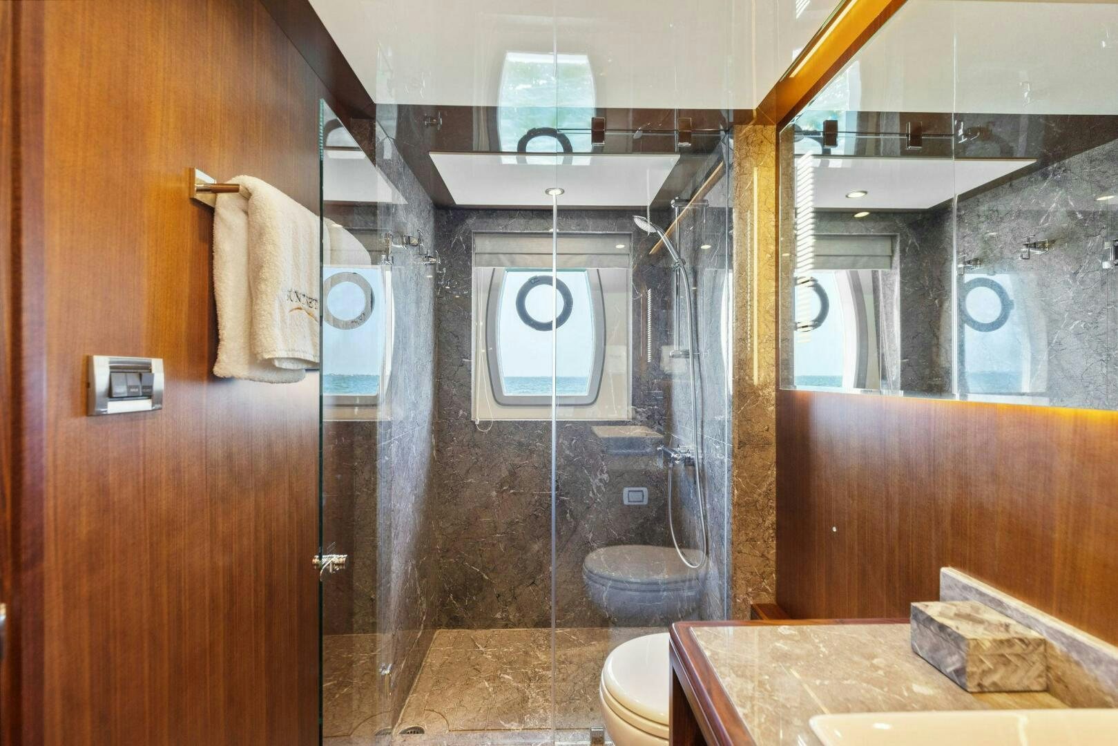 a bathroom with a glass shower aboard SUNZSET Yacht for Sale